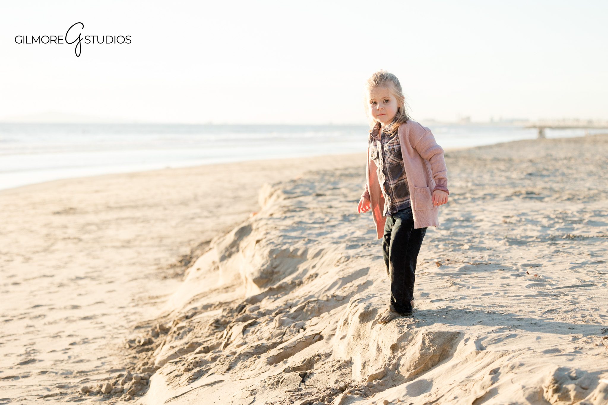 Pier family photography with a young daughter and coastal backdrop
Newport Beach family photographer documenting family interaction at the pier