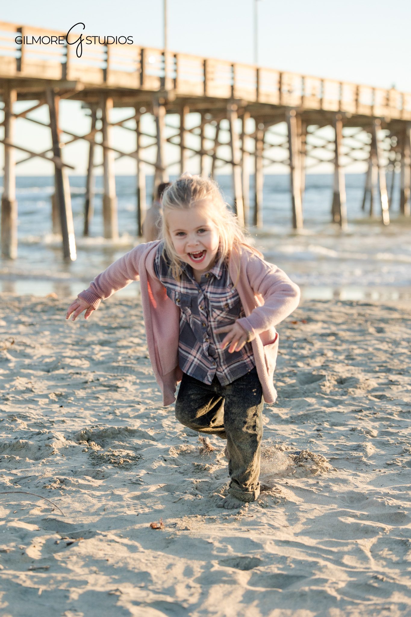 Beach family photography session with a young daughter at Newport Pier
Newport Beach family photographer documenting a pier session with a young child