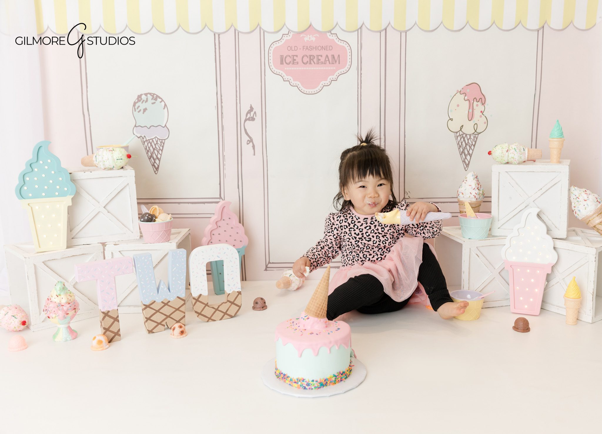 Toddler milestone portrait photography at an ice cream shop
Child birthday photography session featuring a 2 year old enjoying a treat