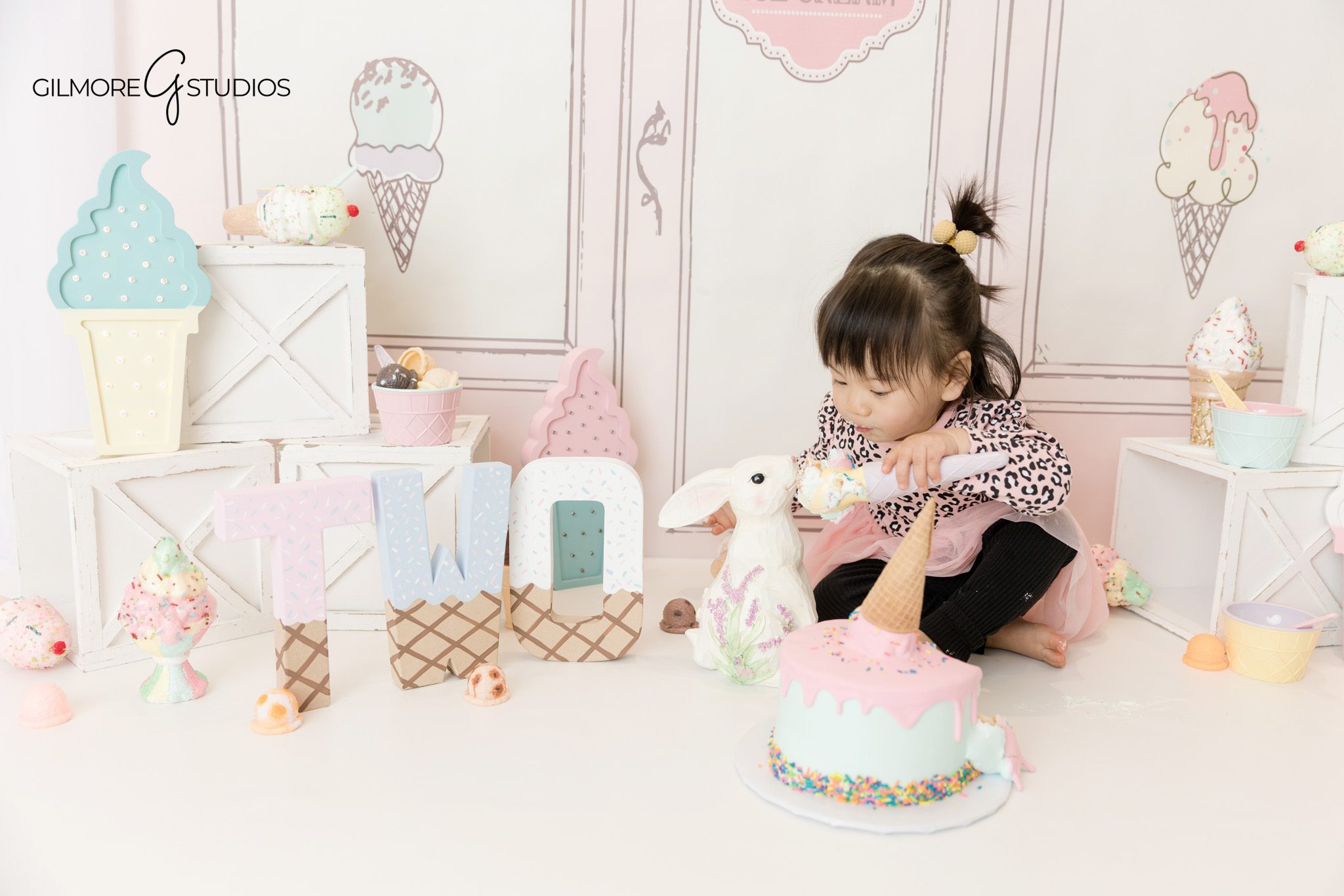 Ice cream shop birthday photography capturing playful toddler moments
Birthday portrait photography of a 2 year old at an ice cream shop