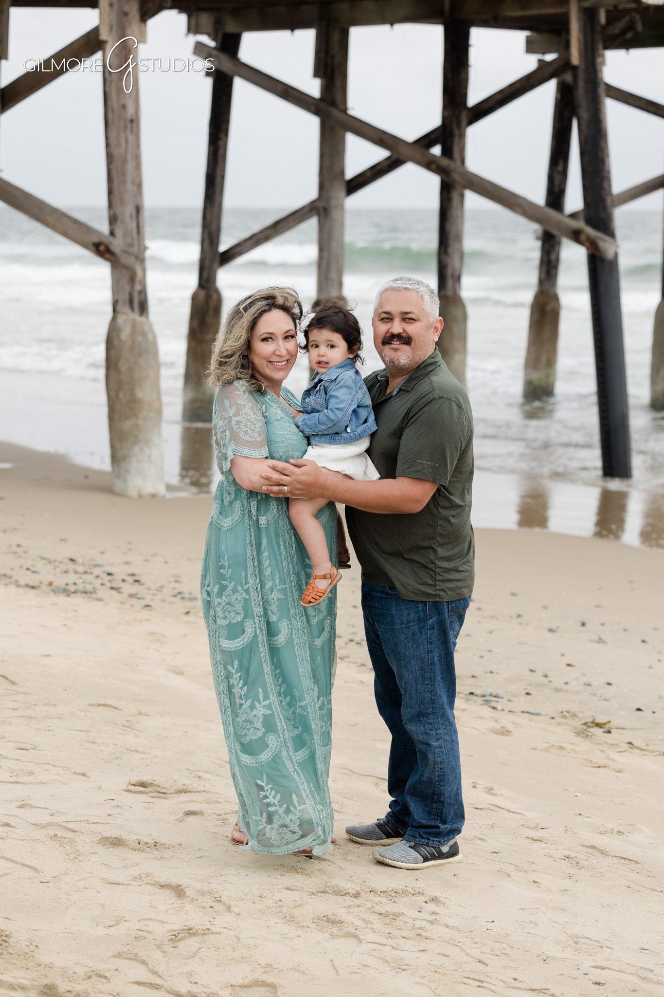 Beach maternity photography session highlighting pregnancy at Newport Pier
Newport Pier maternity portrait photographed with soft neutral tones