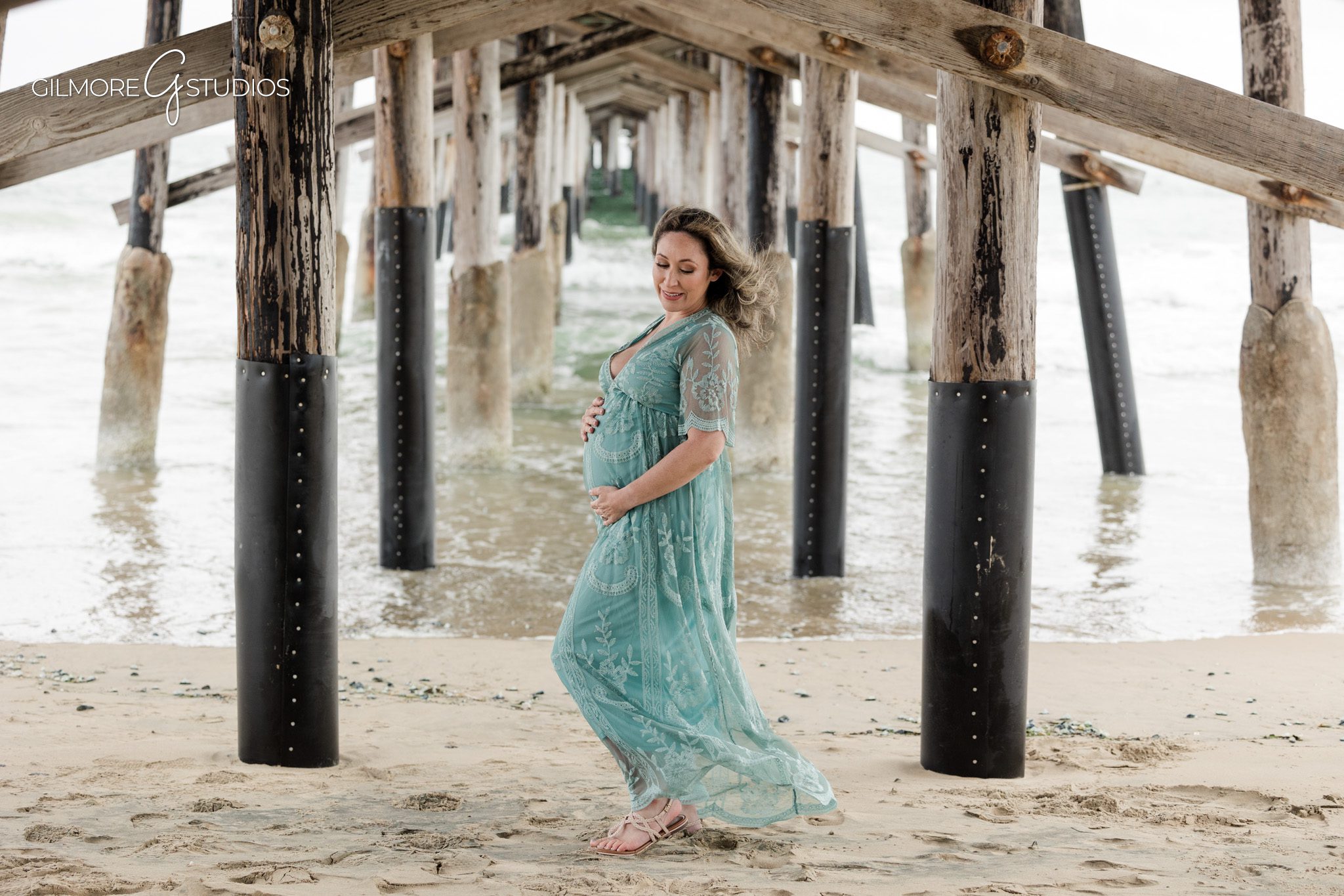 Beach maternity portrait photographed at Newport Pier by a Newport Beach maternity photographer
Newport Pier maternity photography session capturing pregnancy portraits by the ocean