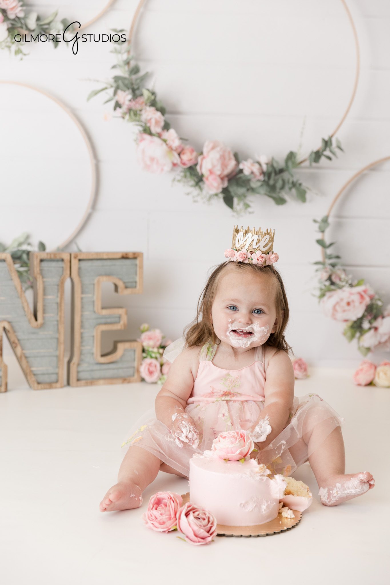 Cake smash photography featuring a one year old portrait in studio

Professional cake smash portrait photographed at Gilmore Studios