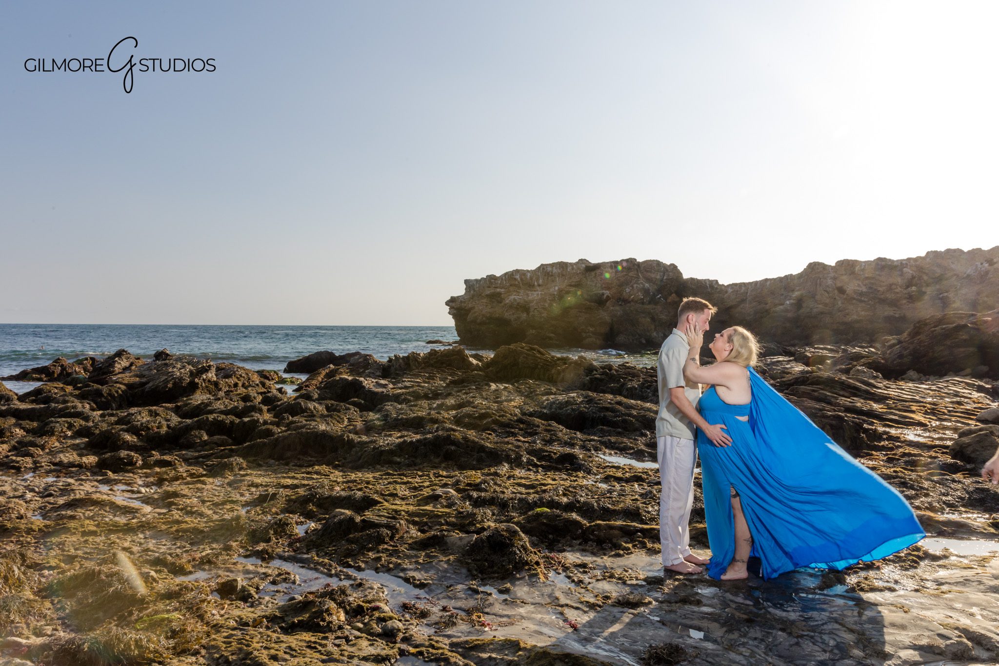 Corona del Mar photographer capturing couple dancing in the waves.

Family portrait photography on sandy beach during sunset glow.