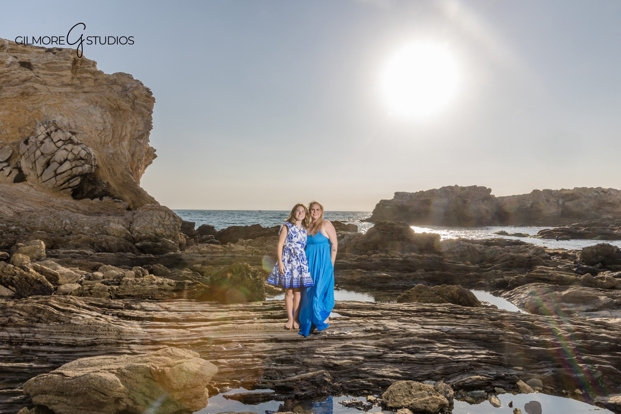 Family session photography showing candid hug at the shoreline.

Engagement portrait photographer capturing natural sunlight on couple.
