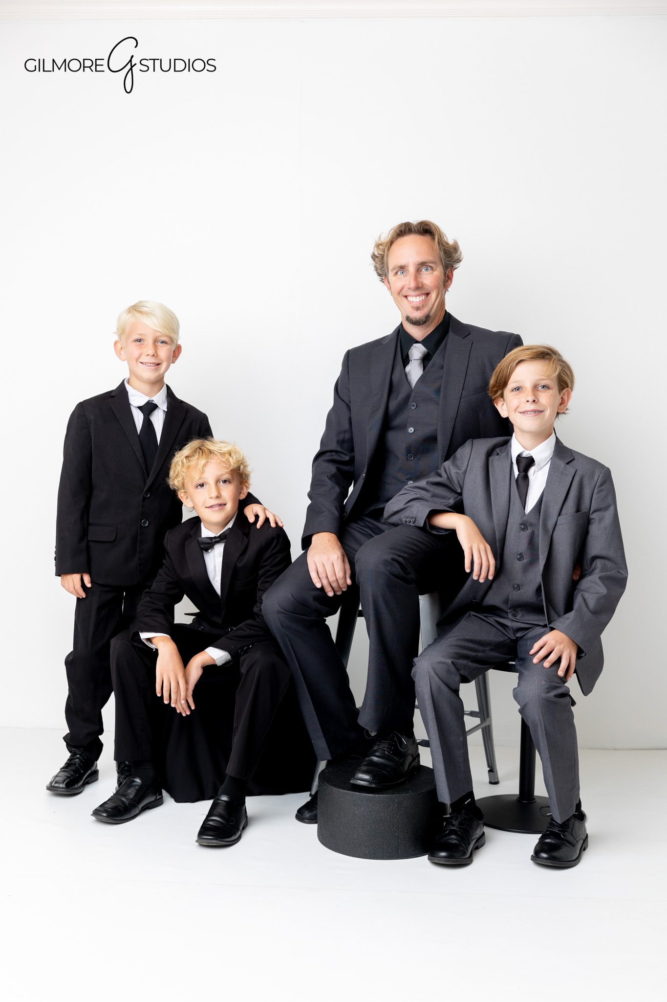 Professional family photographer documenting polished studio session in Newport Beach.

White studio background family portraits with formal coordinated wardrobe.