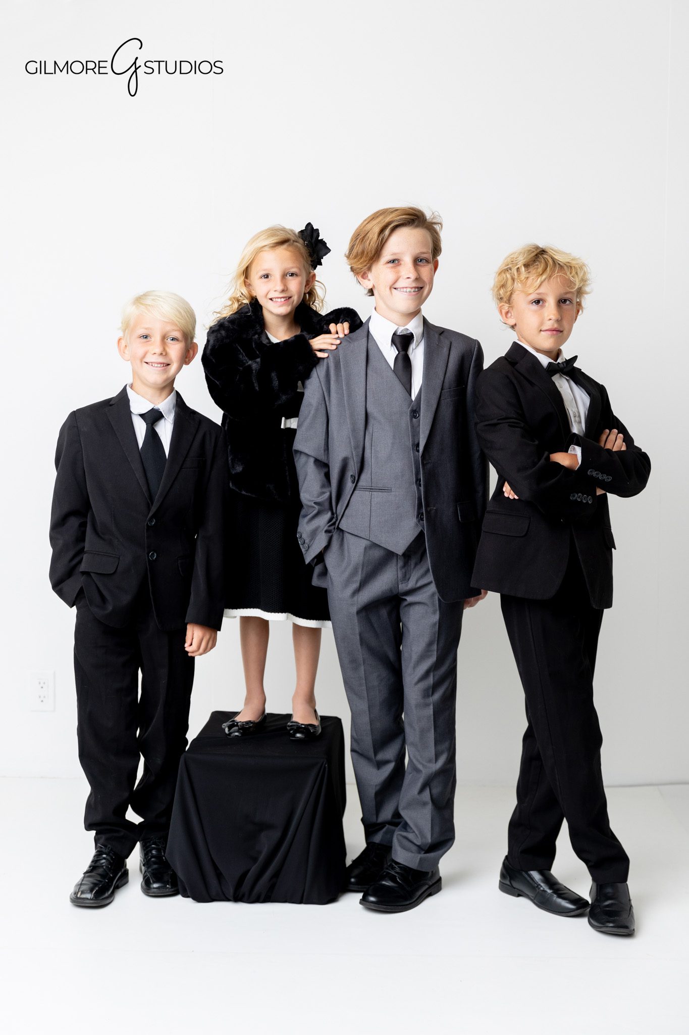 White backdrop family portrait photographed by Newport Beach photographer.

Gilmore Studios family photography session featuring formal coordinated outfits.