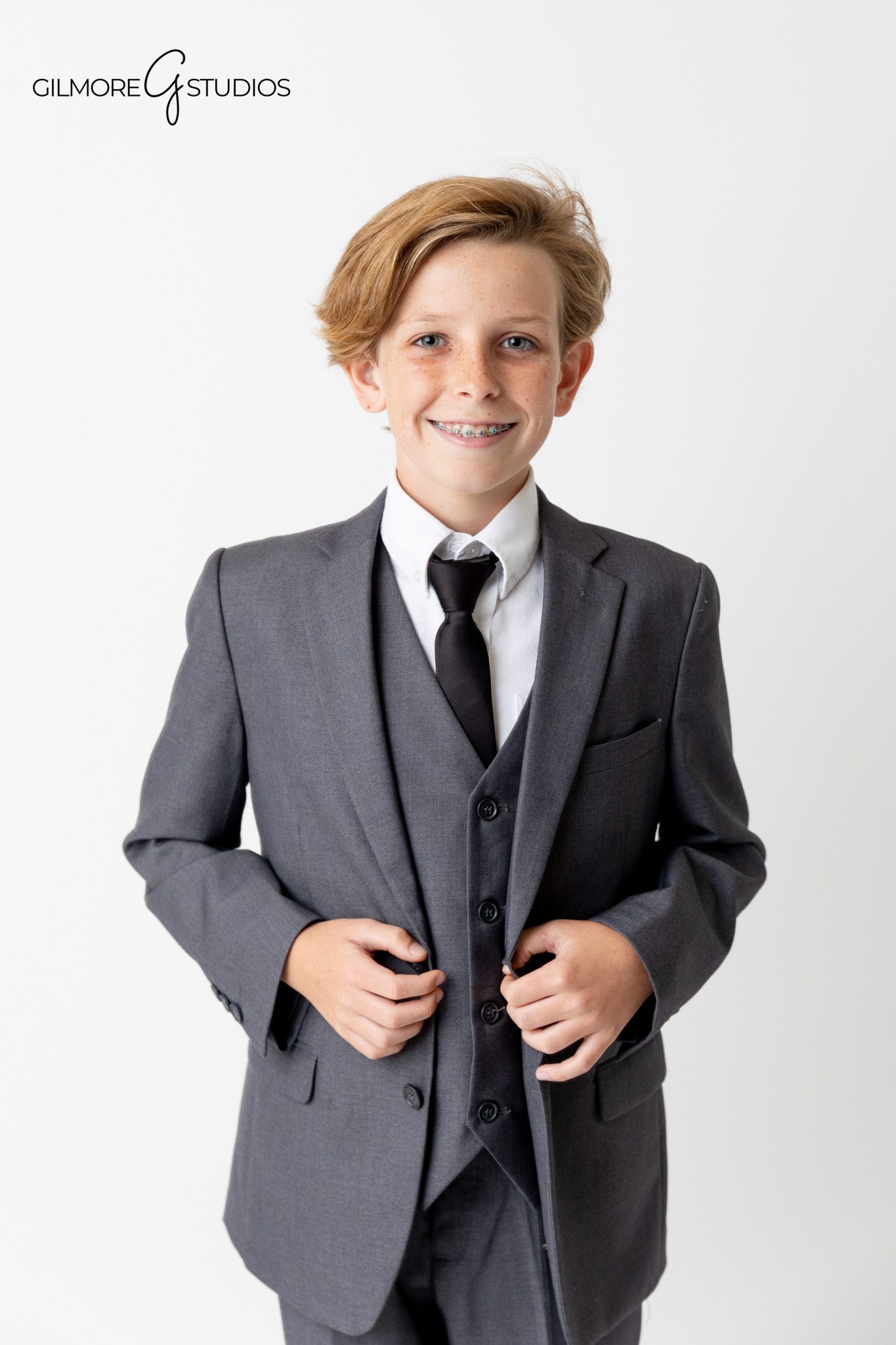 Professional photography capturing clean and minimal family studio session.

Gilmore Studios photographer capturing sophisticated family portraits in formal wear.