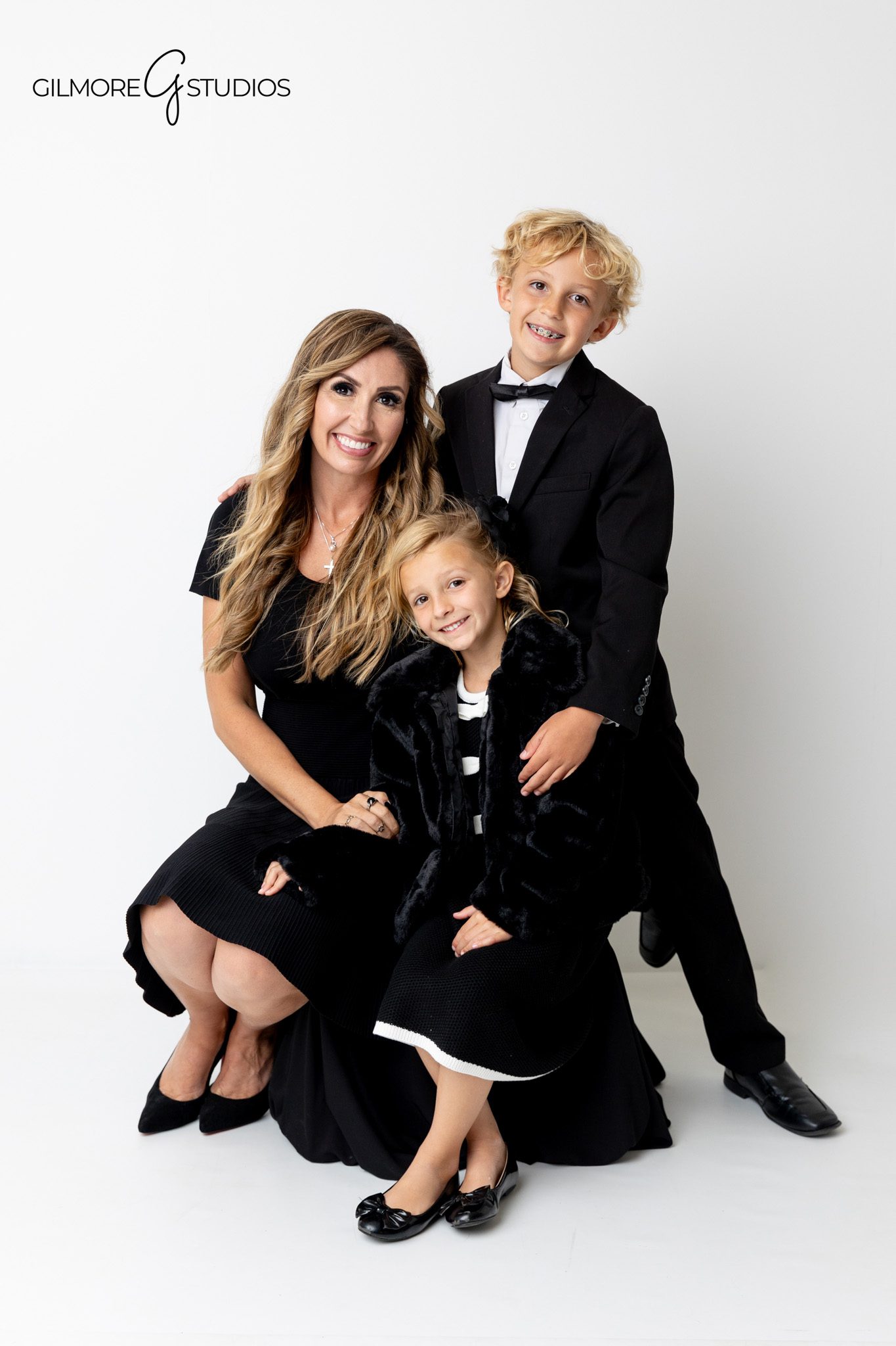 Studio photographer documenting sophisticated family portrait look.

Family portrait photography with crisp white studio setting in Newport Beach.