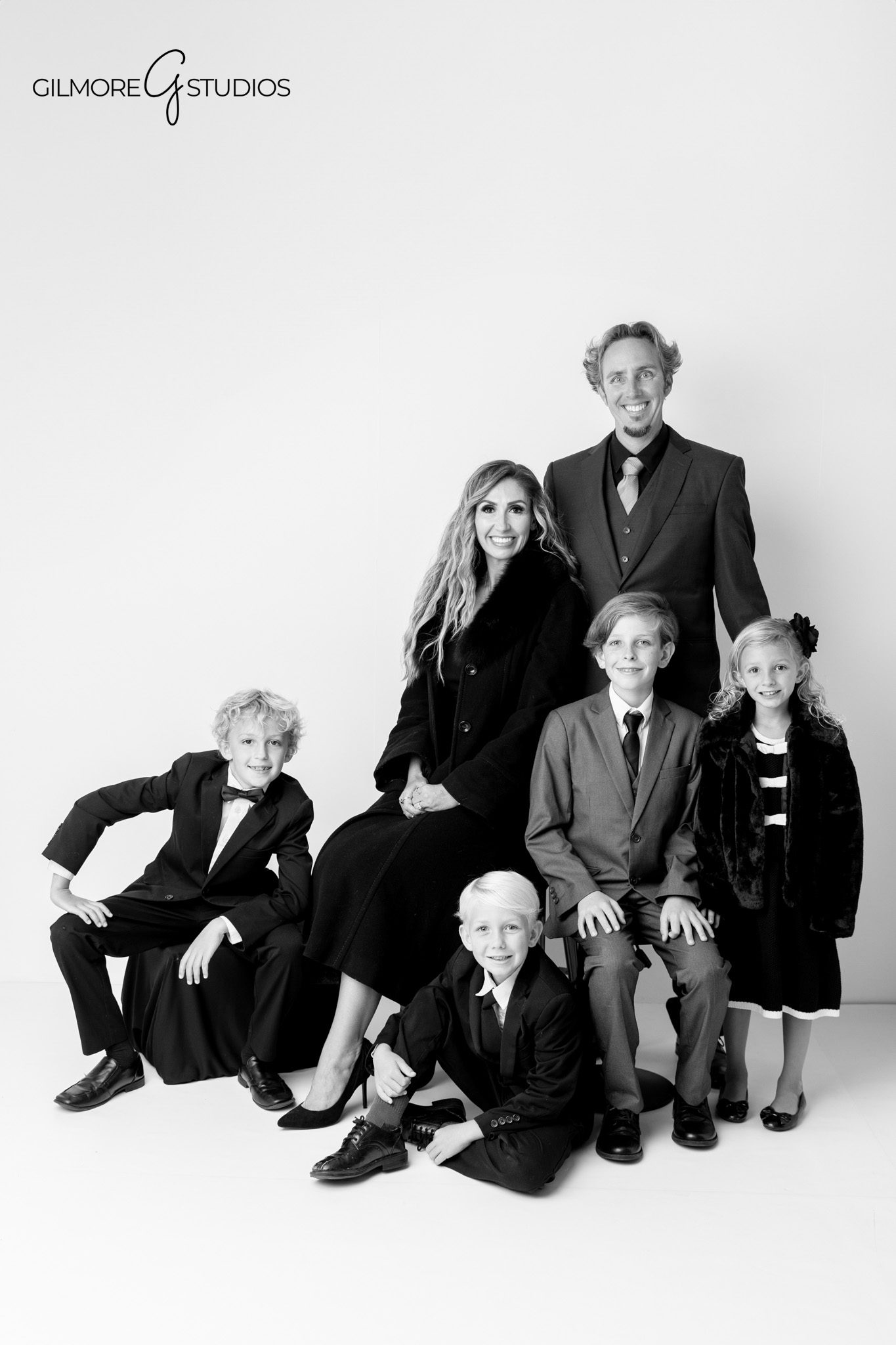 Studio family portraits photographed with classic lighting in Newport Beach.

Newport Beach photographer capturing siblings in matching formal outfits.