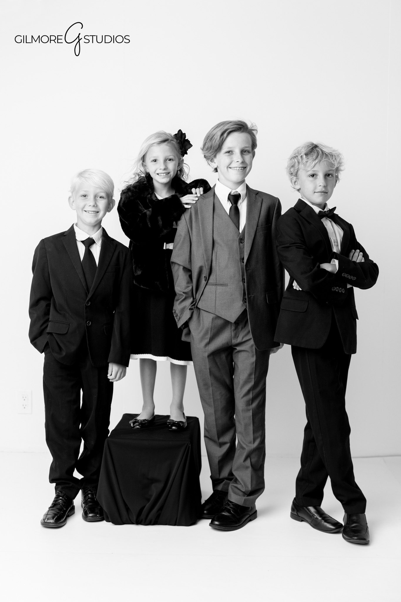 Newport Beach photographer capturing refined family studio composition.

White background portrait photography of parents holding children.