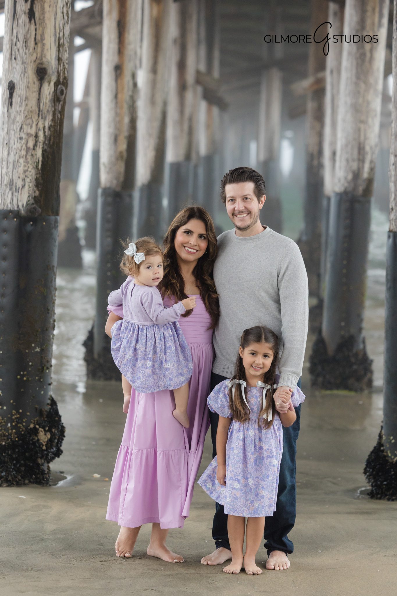Newport Pier family photographer capturing portraits during foggy beach session.

Foggy beach family photography at Newport Pier with natural coastal light.