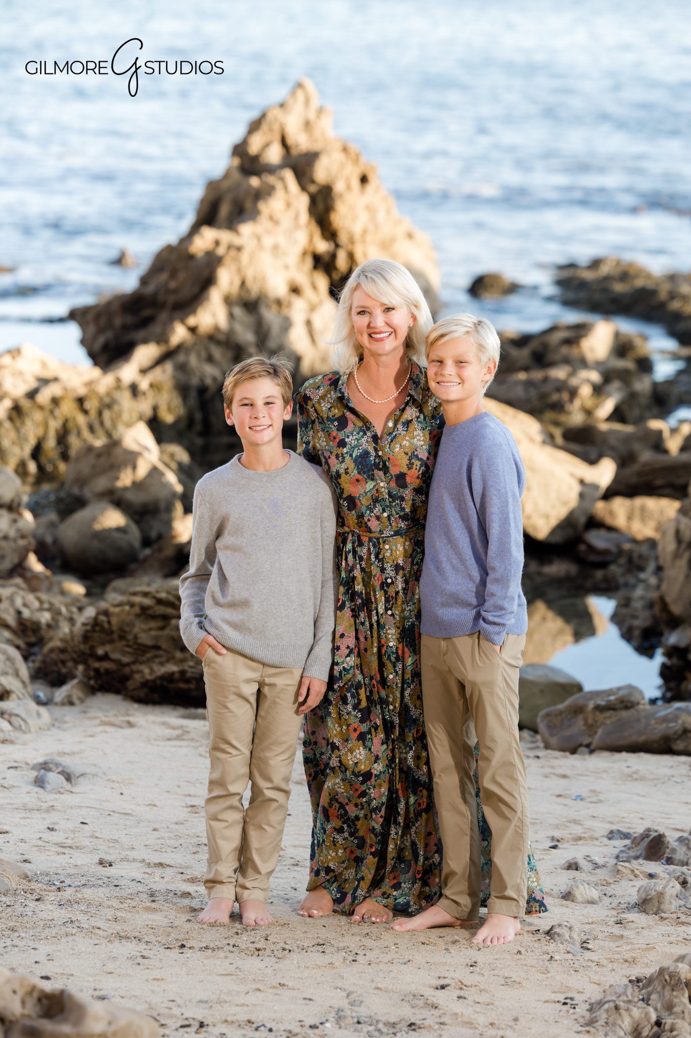 Little Corona portrait photography showing family together on rocky cliffs.

Gilmore Studios photographer capturing warm sunset family session in CDM.