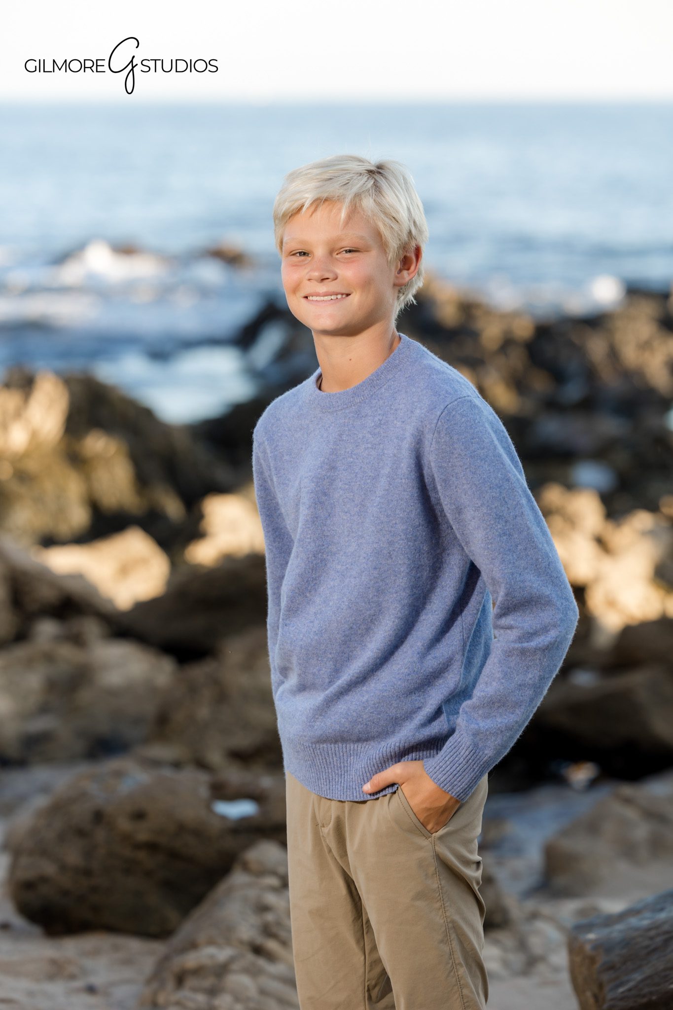 Beach photographer capturing natural family poses in Orange County.

Gilmore Studios portrait photography at Little Corona shoreline.