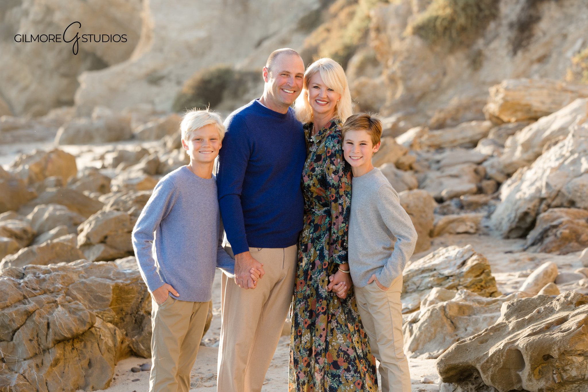 Photographer capturing family cuddles and connection on beach rocks.

Coastal Orange County family photography session at Little Corona.