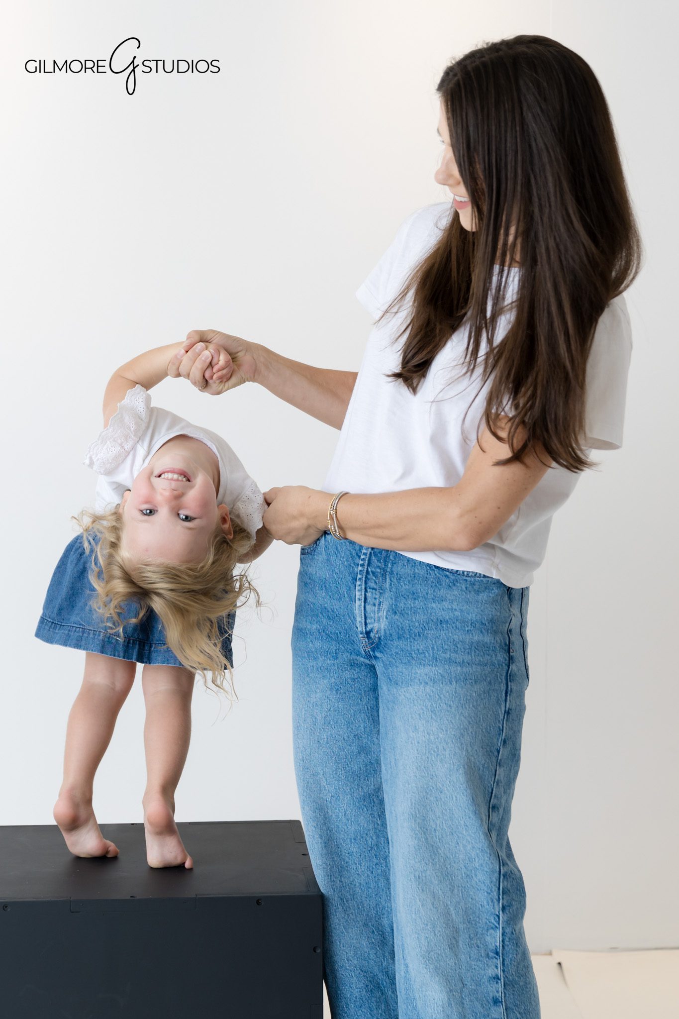 Bright white studio family photography with coordinated clothing.

Minimalist family portrait photographer capturing timeless studio look.
