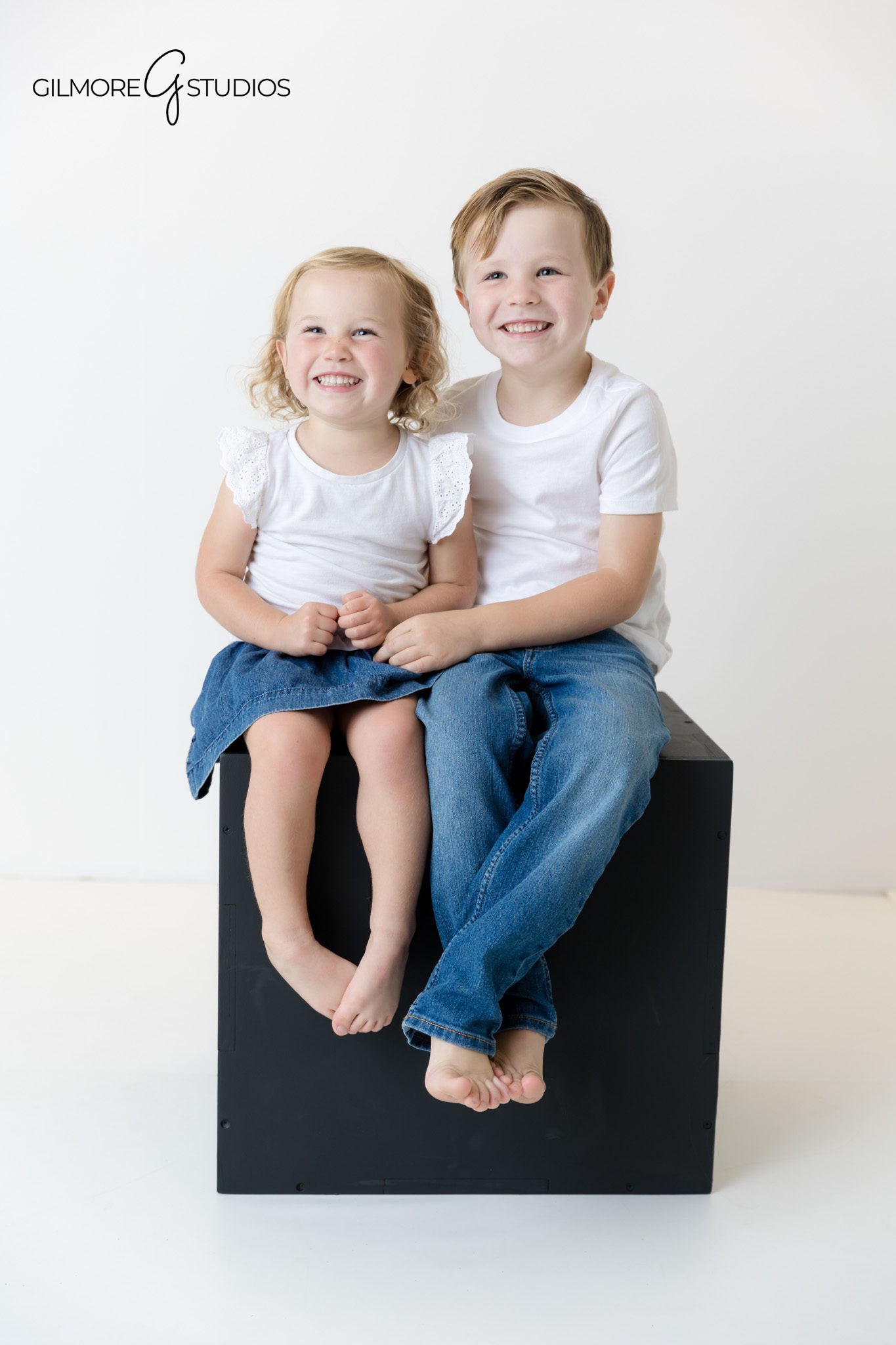 Orange County photography session with family dressed in white and denim.

Soft studio lighting family portraits with matching white shirts.
