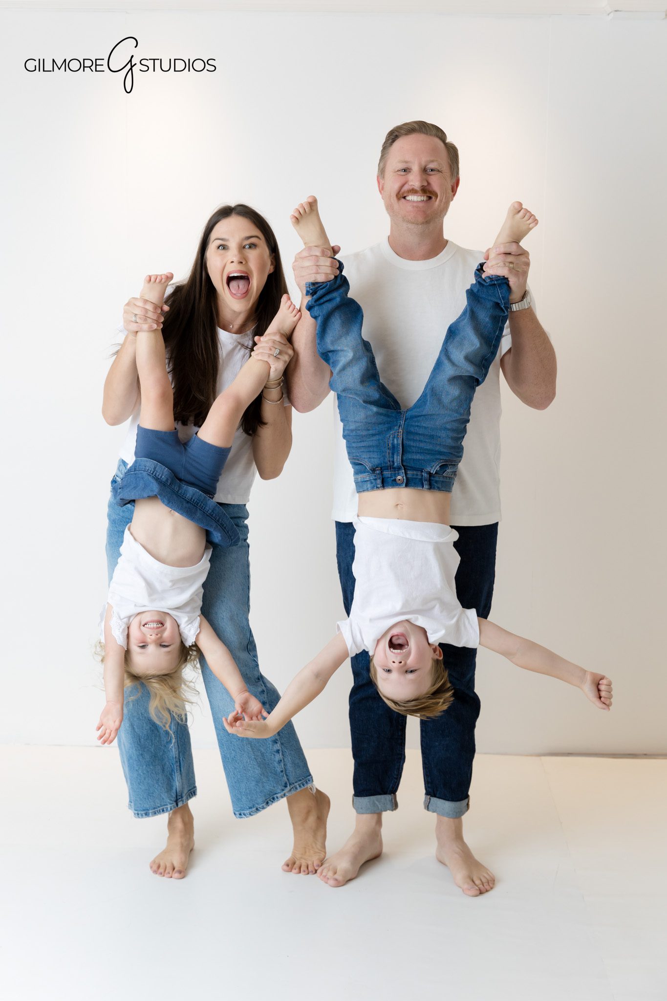 Clean white background family portrait by Orange County photographer.

Family photographer capturing timeless studio images in coordinated outfits.