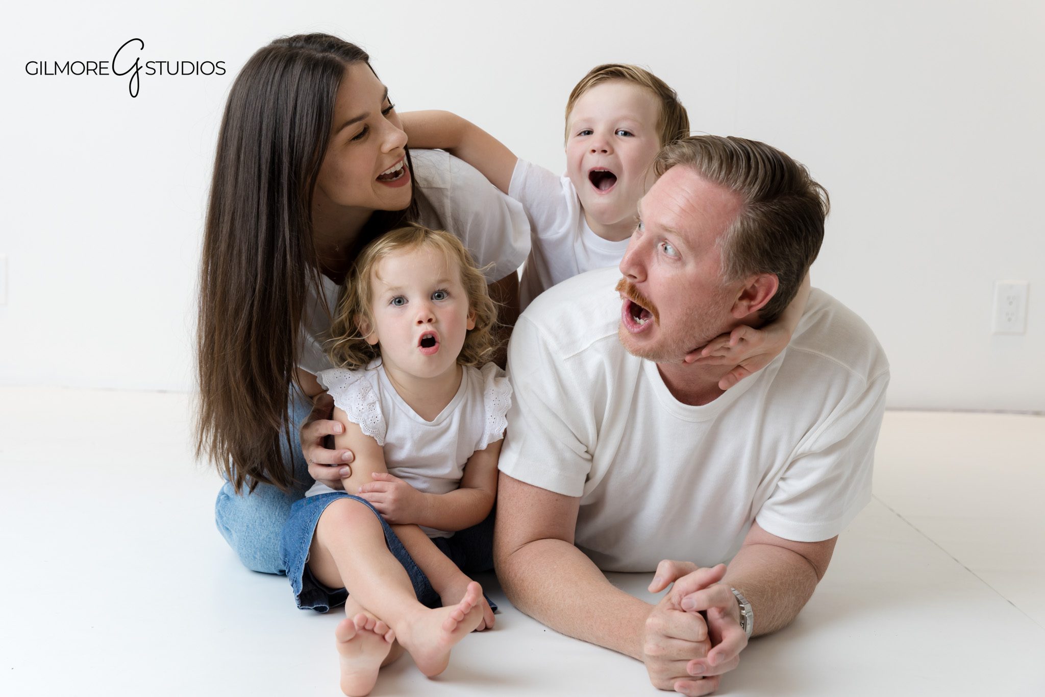 Orange County photographer documenting simple and classic family session.

Coordinated white shirt family portraits in professional photography studio.