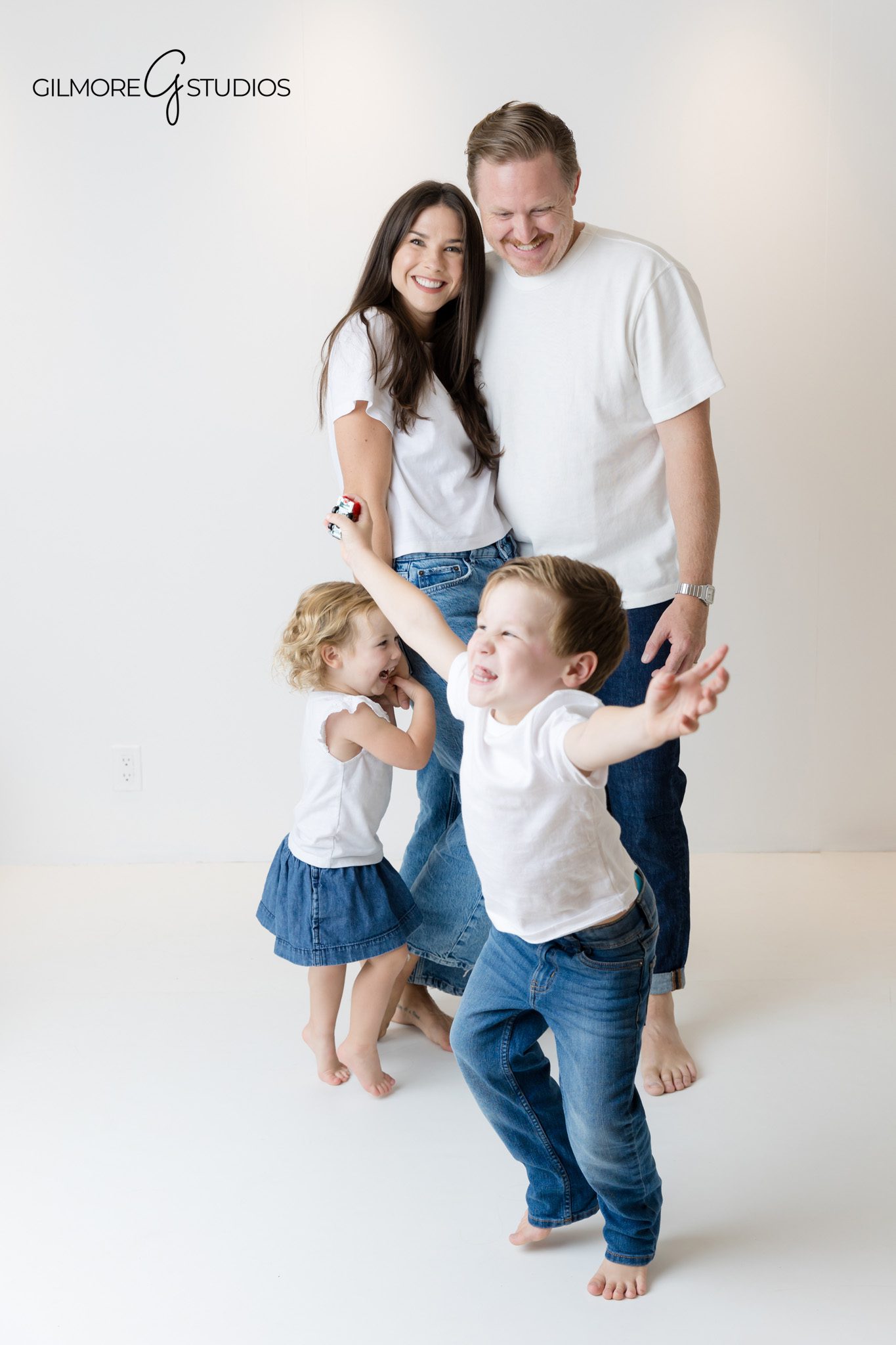 Classic white background photography for families with matching outfits.

Orange County portrait photographer documenting family connection.
