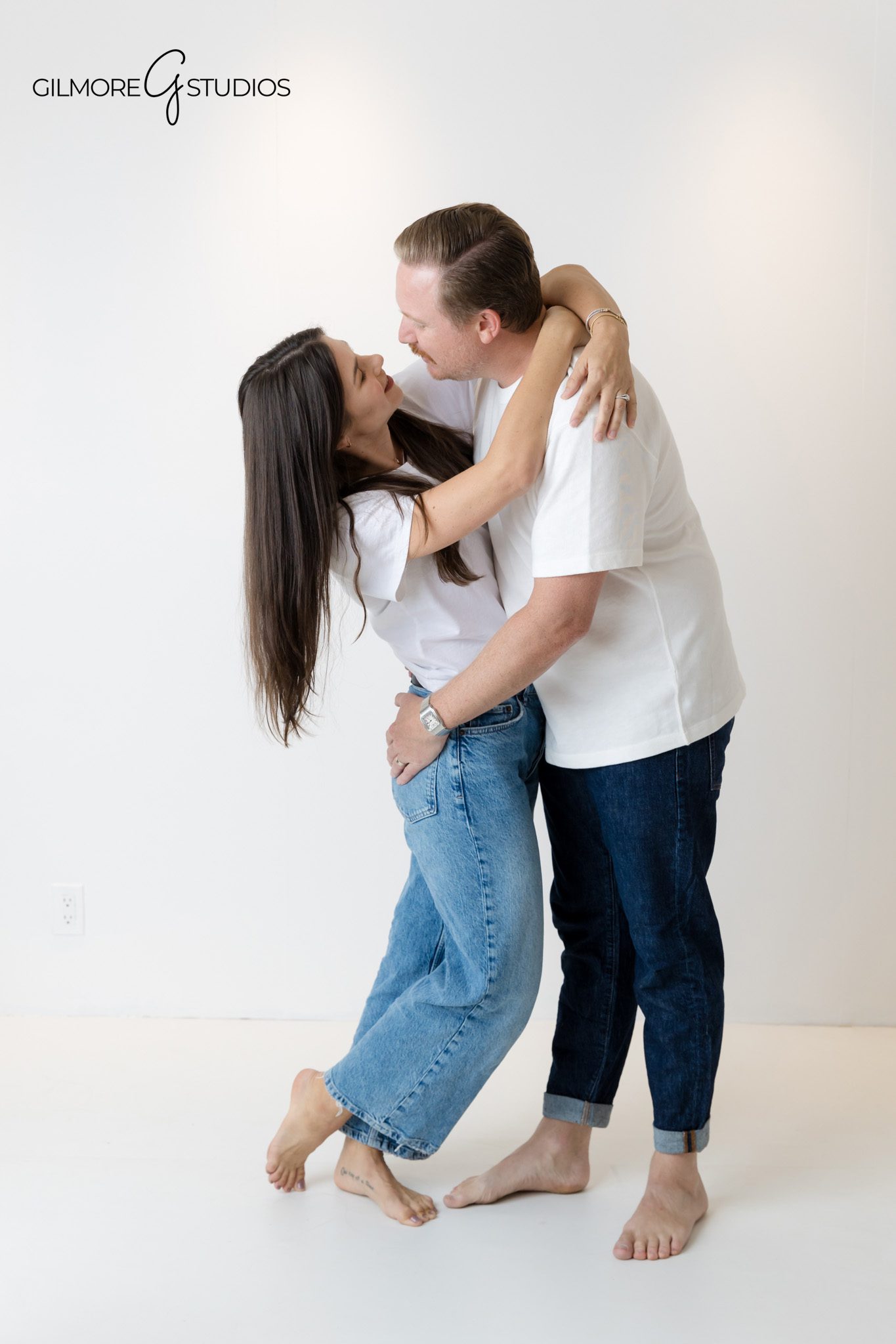 Professional portrait session featuring parents and kids in white shirts.

Family photography with minimal styling on a pure white backdrop.