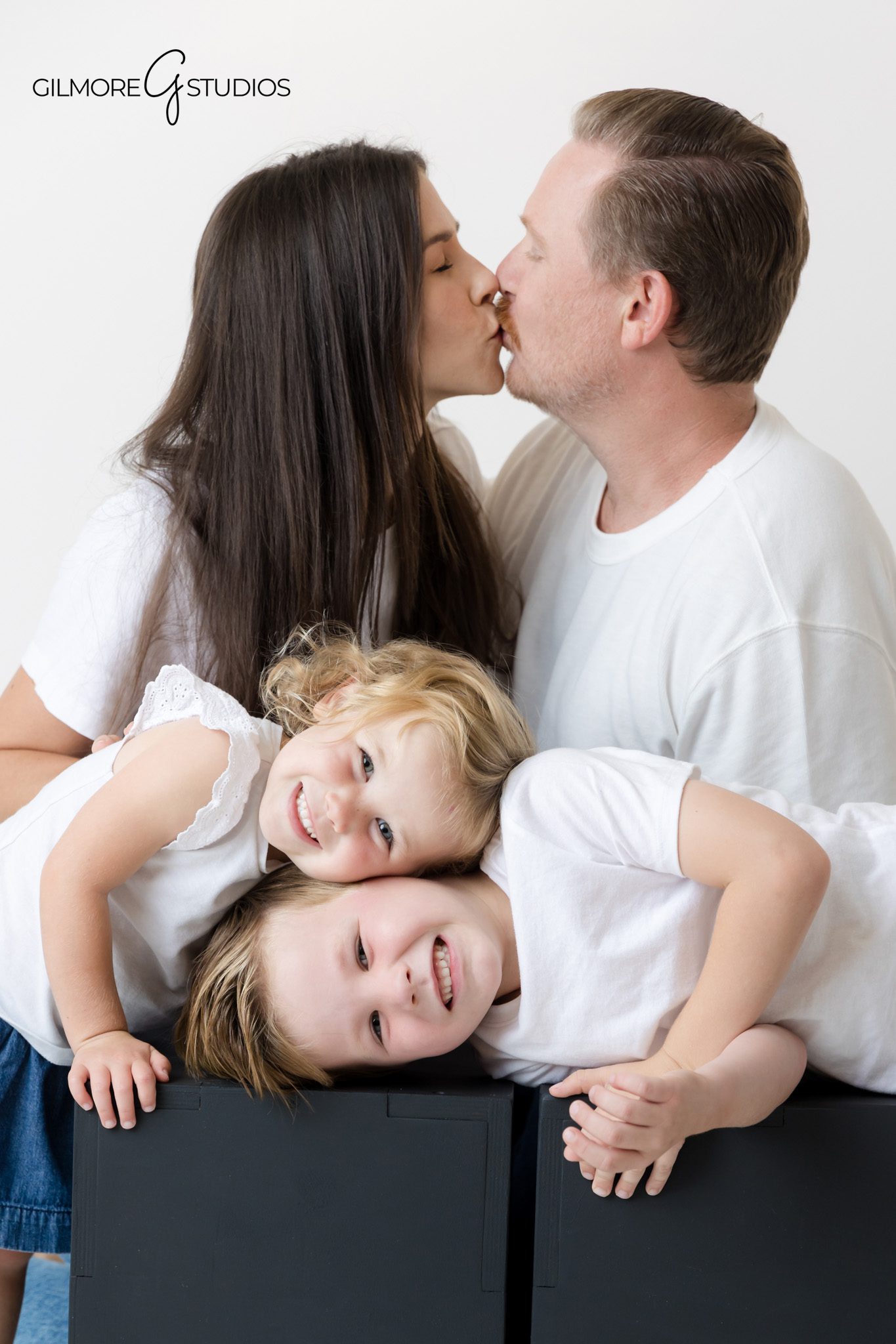 Clean studio portraits with bright white tops and denim jeans.

Orange County photographer capturing joyful family expressions.