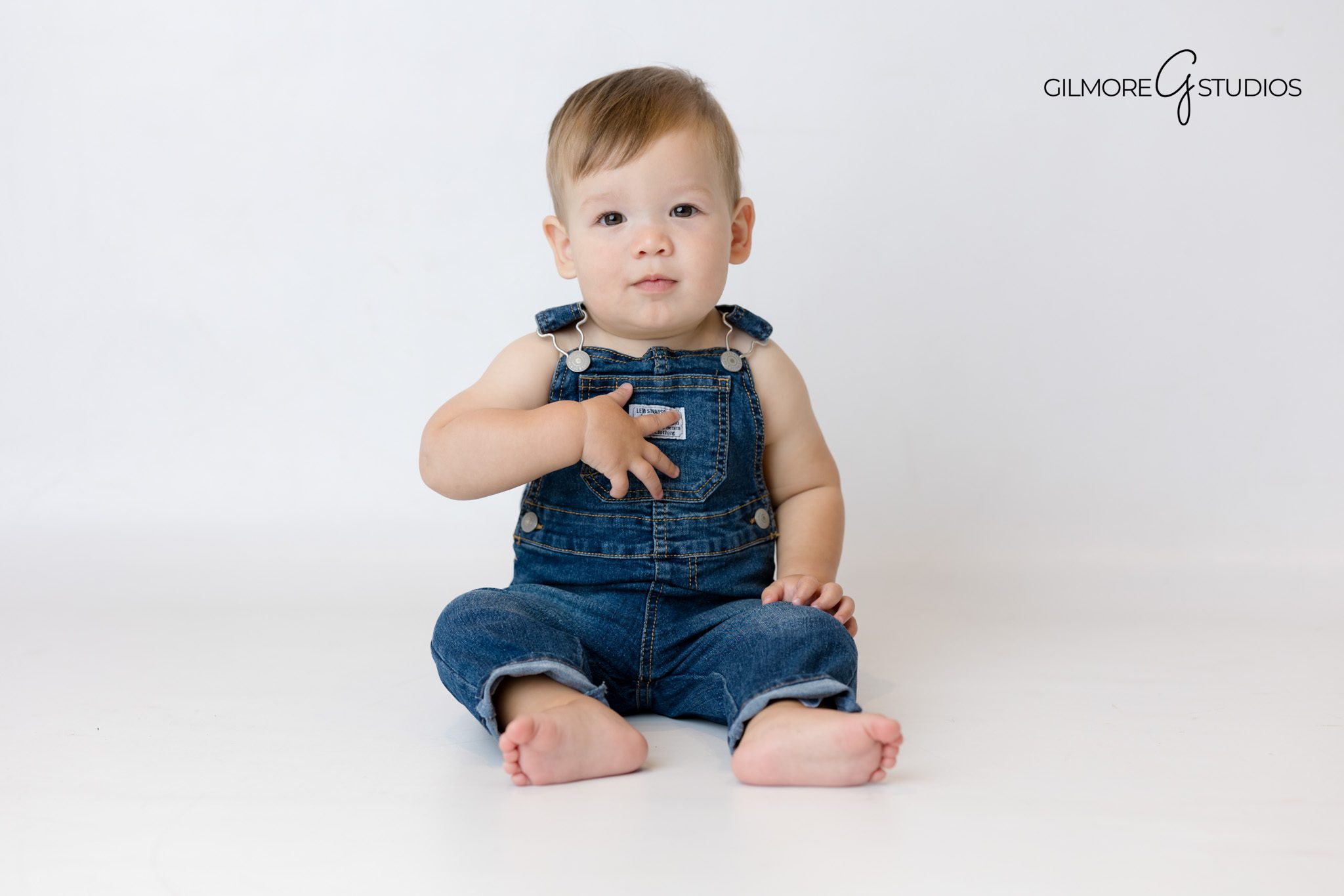 Baby sitting on Sesame Street themed backdrop during portraits.

Photography session featuring Elmo first birthday theme.
