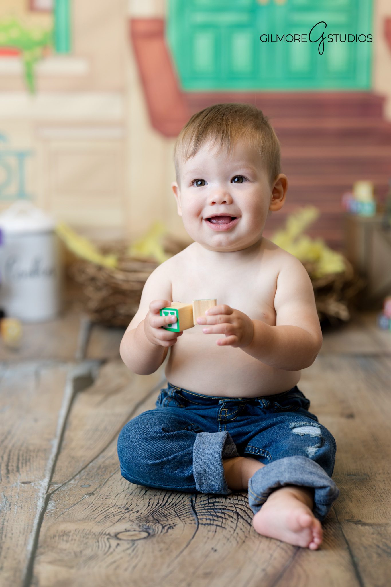 First birthday photography with colorful Elmo decorations.

Baby smiling during Sesame Street portrait session in studio.