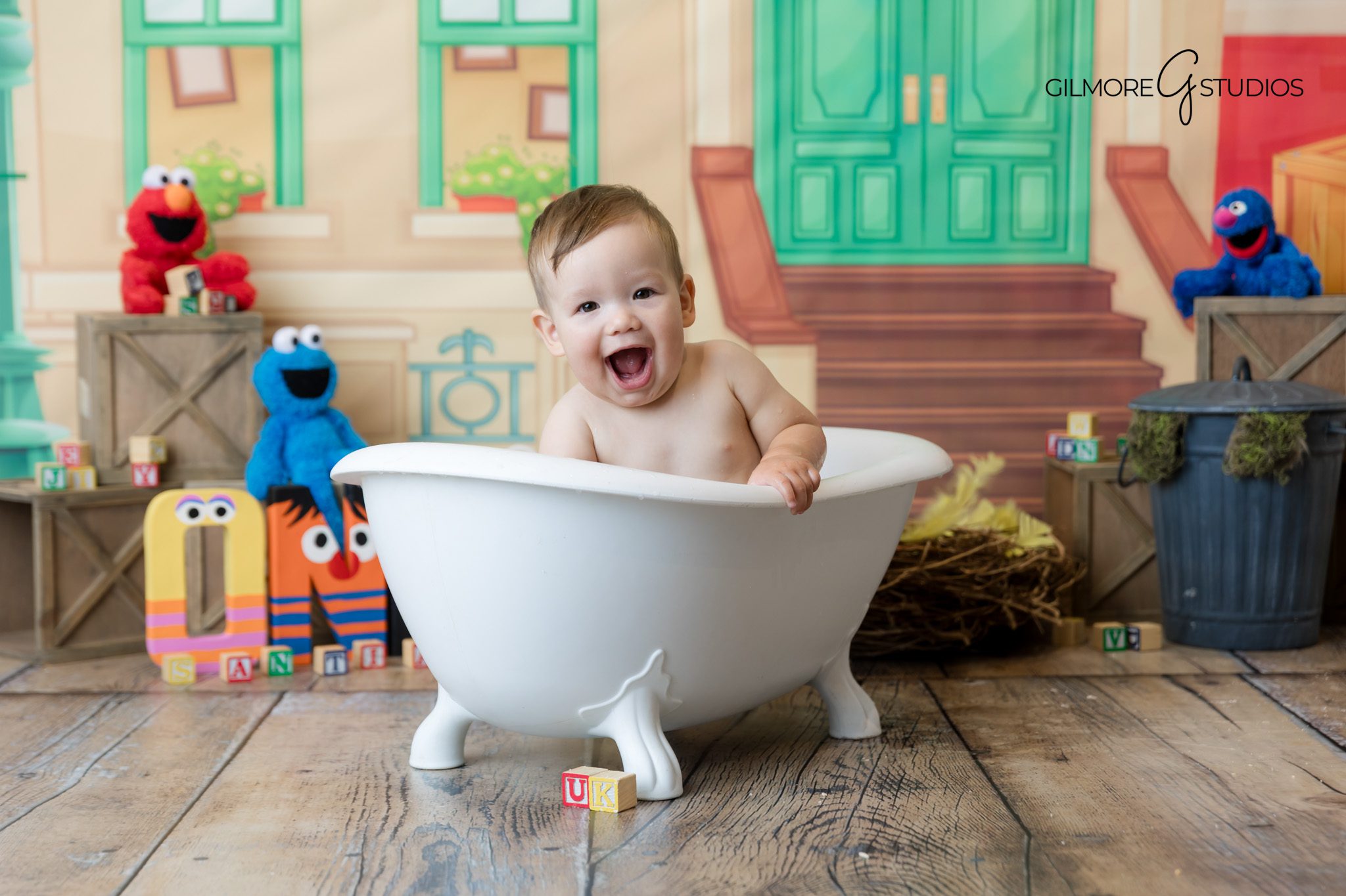 Santa Ana cake smash portraits with colorful props.

Photography of baby holding cake during Sesame Street shoot.