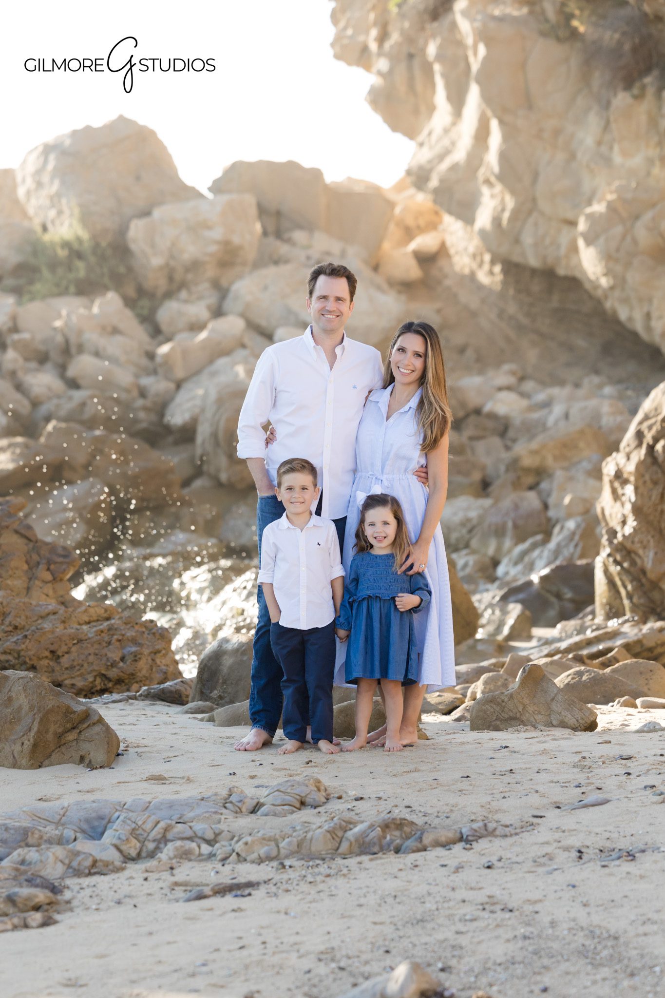 Little Corona family photographer capturing candid beach moments.

Family portrait photography near rocky cliffs at Corona del Mar Beach.