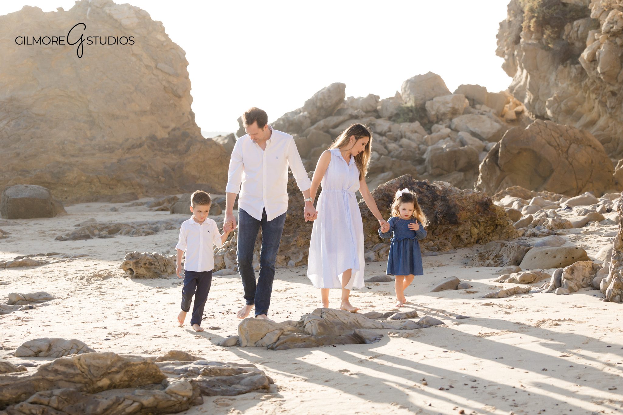 Natural light photographer capturing relaxed family portraits on the sand.

Family photography showing parents holding kids at Little Corona Beach.