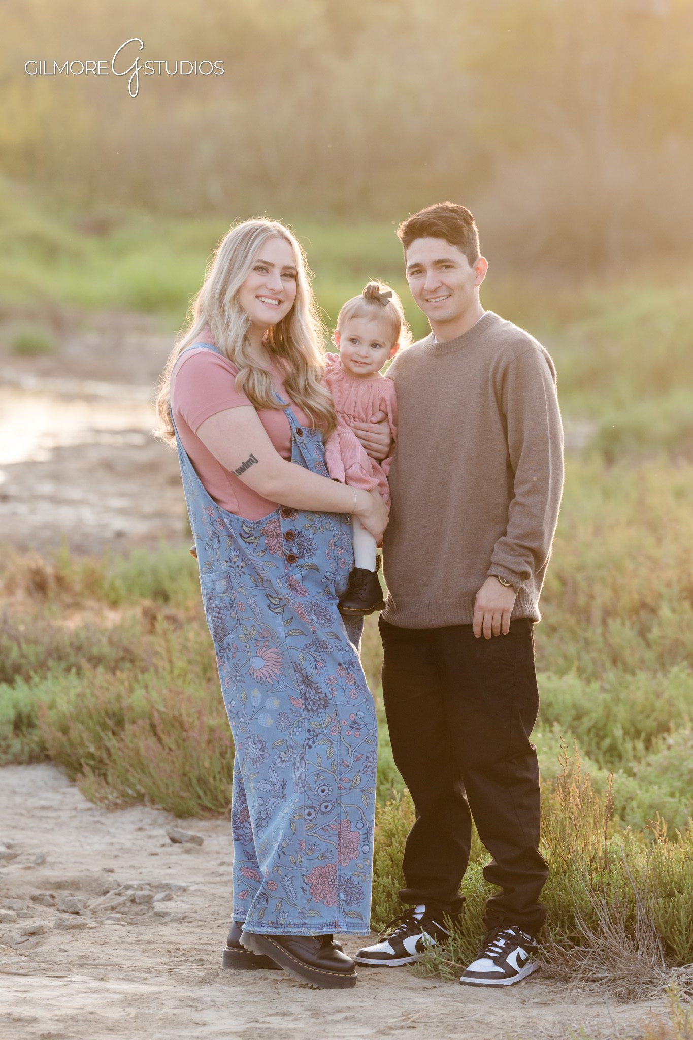 Extended family session photographed by Gilmore Studios at Back Bay.

Photographer capturing cousins during Newport Beach family session.