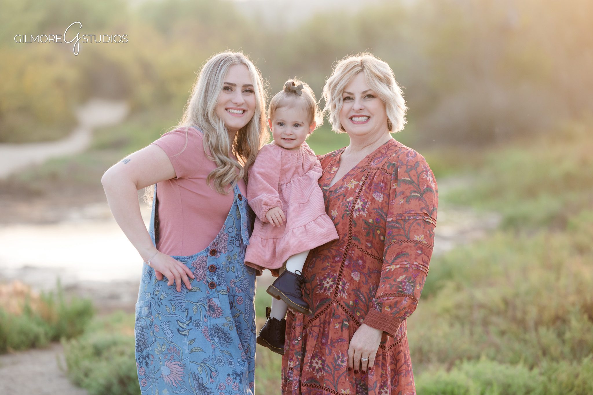 Newport Beach portrait photographer capturing siblings sitting on trail.

Large family portrait photography with Back Bay marsh behind them.