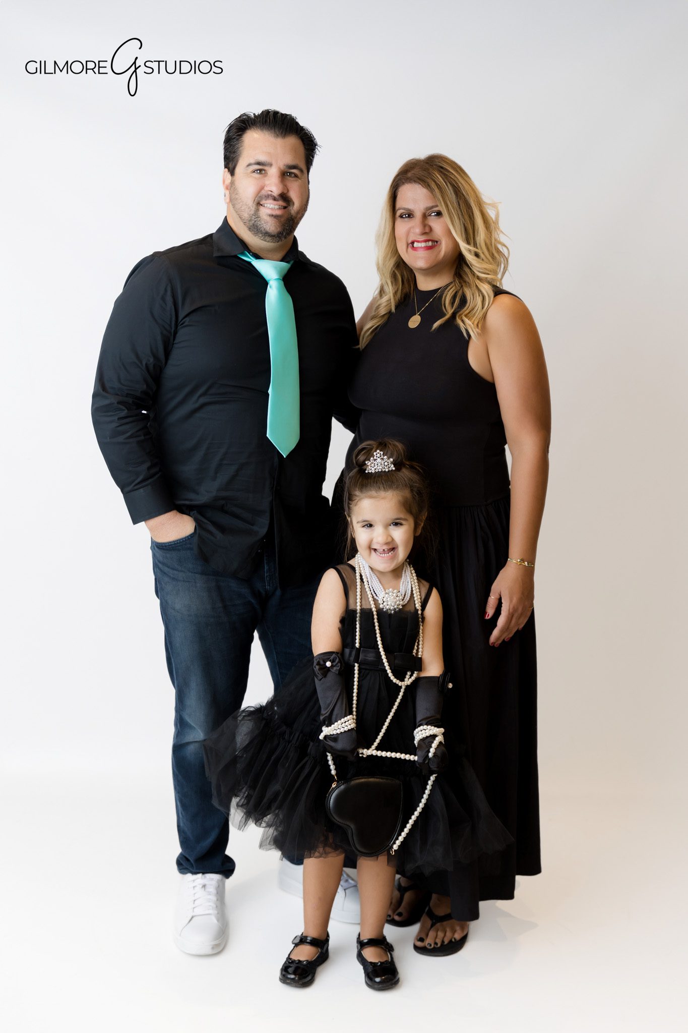 Birthday photographer capturing girl posing with Tiffany style gifts.
Tiffany theme studio photography for luxury birthday portraits.