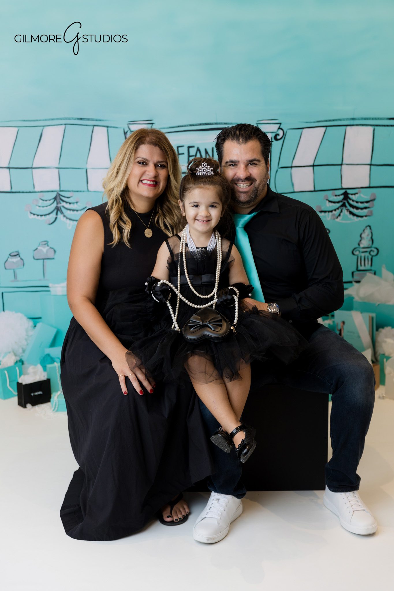 Girl turning three photographed in elegant Tiffany color palette.
Tiffany inspired birthday photography capturing pastel styling.