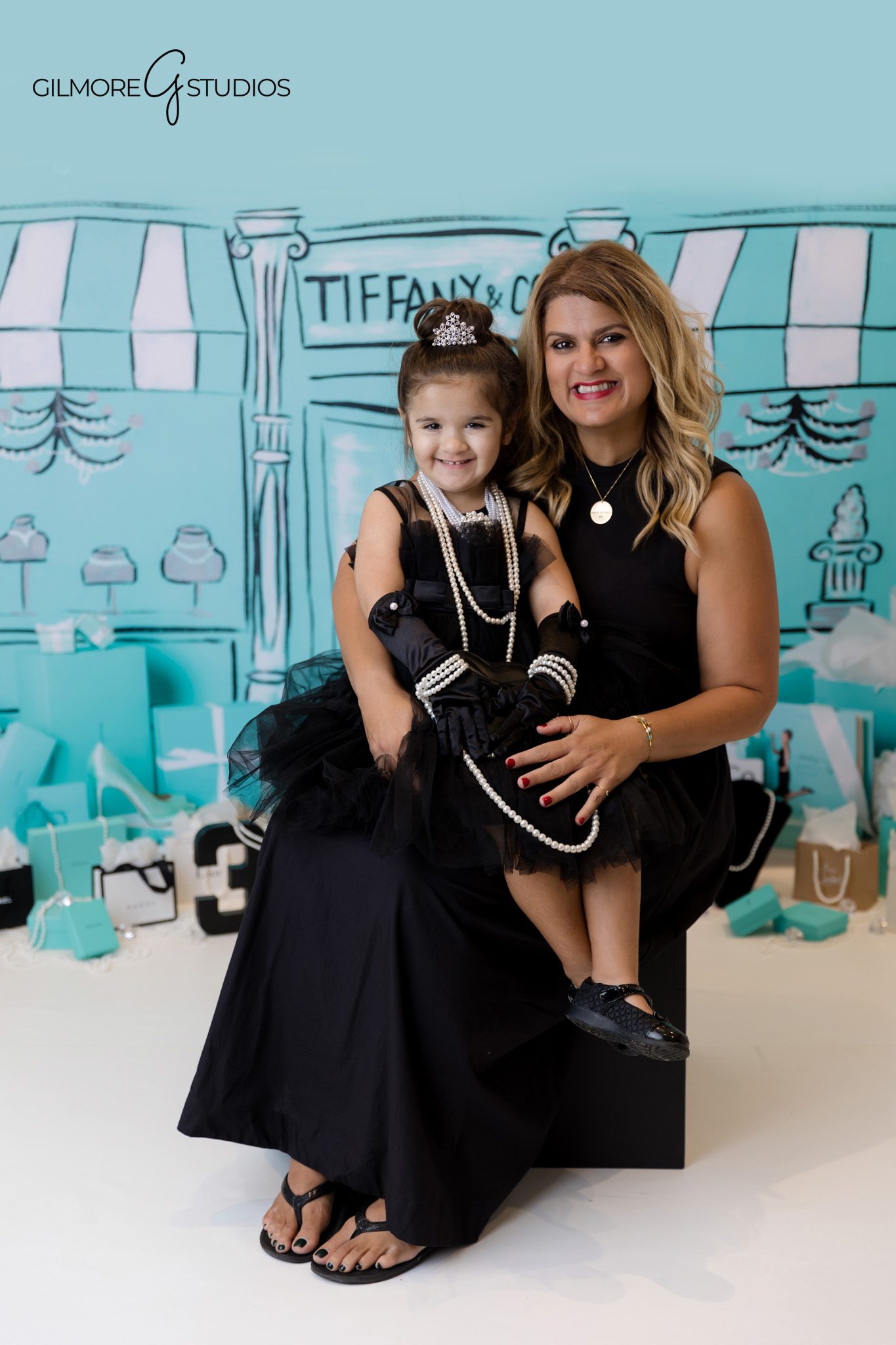 Photographer capturing three year old surrounded by Tiffany blue décor.
Tiffany theme portrait photography with pearl and ribbon accents.