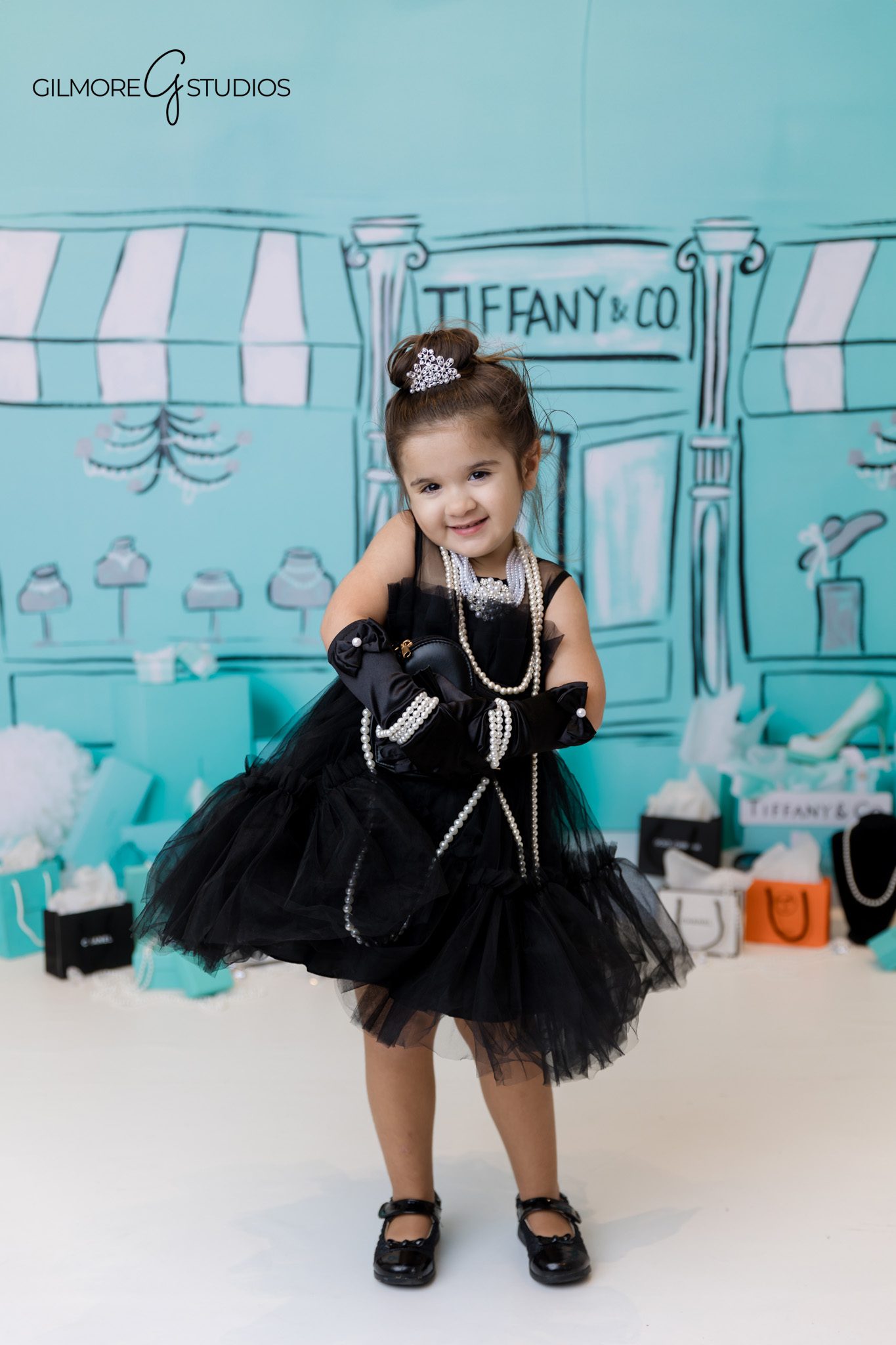 Tiffany’s inspired birthday portrait photographer capturing birthday girl smiling.
Luxury Tiffany birthday theme photography with white and turquoise backdrop.