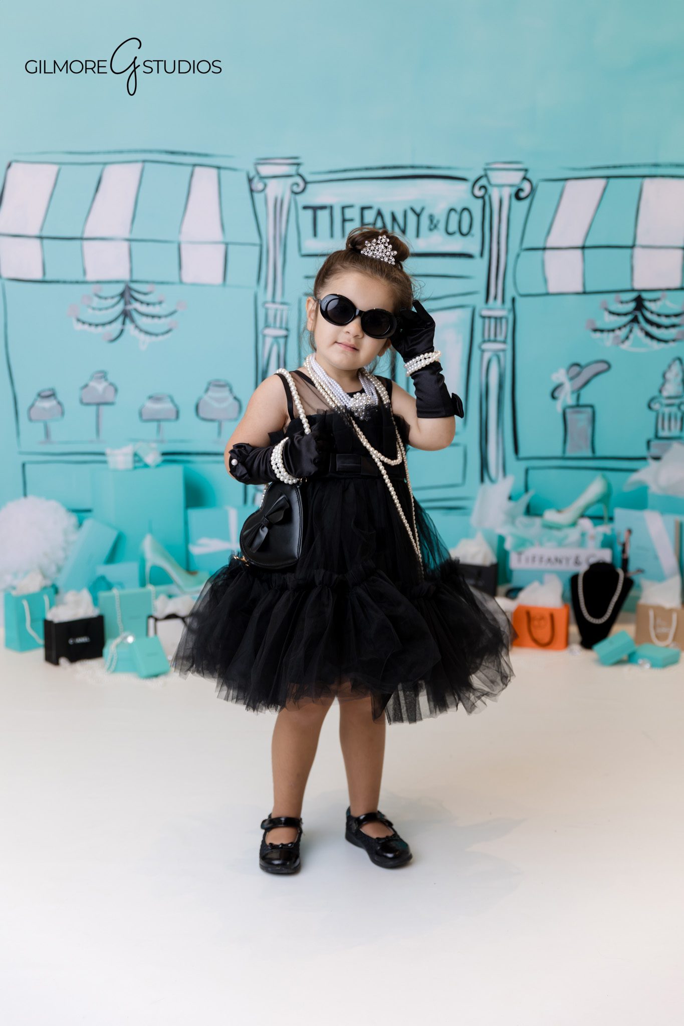 Tiffany box birthday portrait of three year old photographed in Orange County studio.
Three year old birthday girl photographed with Tiffany blue balloons.