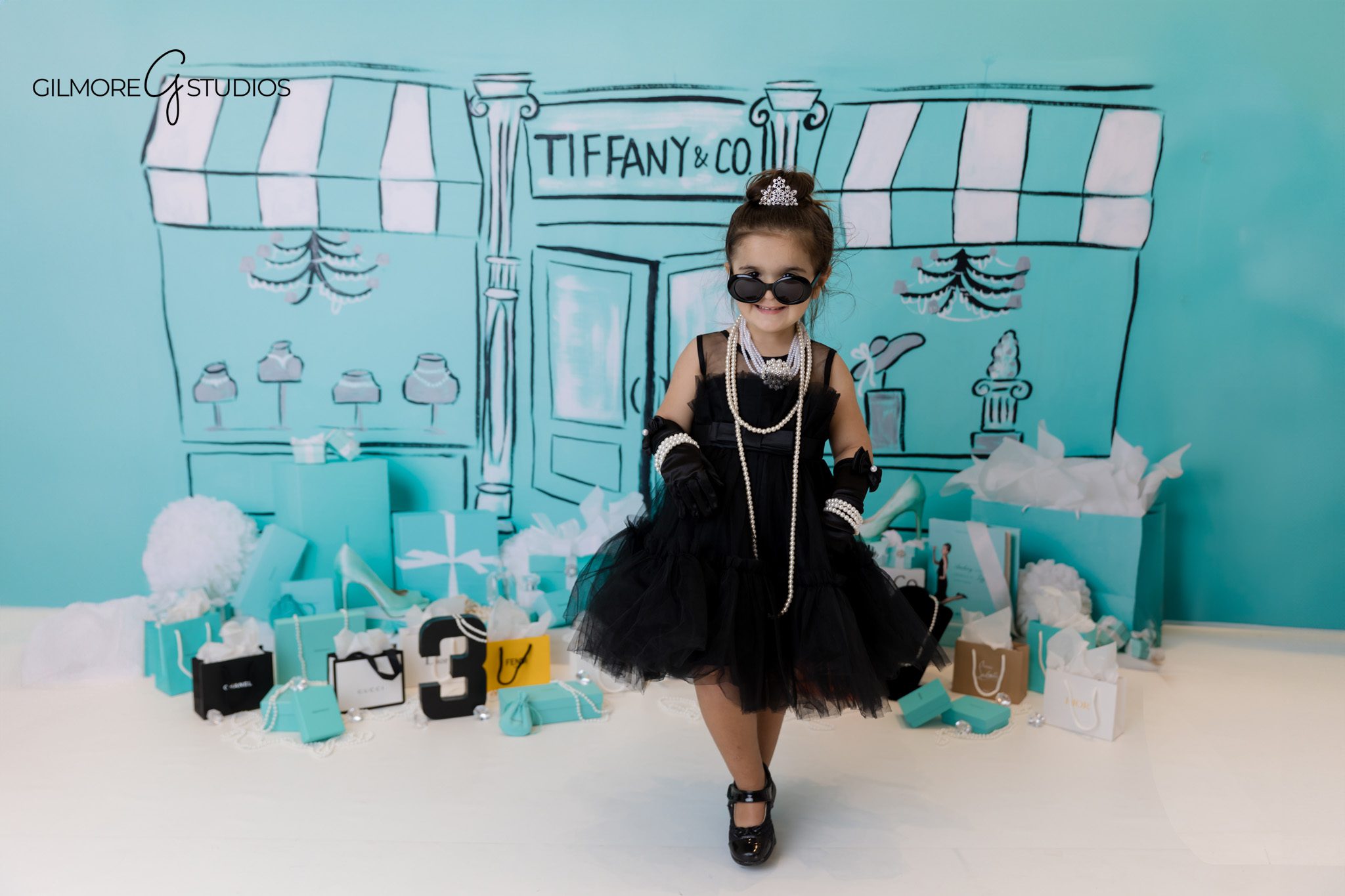 Birthday party theme photography inspired by Tiffany blue elegance.
Three year old girl photographed in luxury themed birthday set.