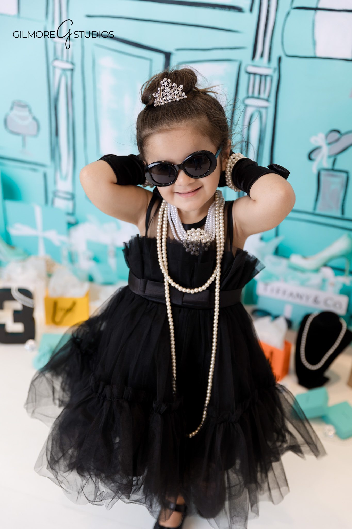 Elegant Tiffany blue birthday photography with bows and sparkle.
Birthday girl photographed in studio for Tiffany themed celebration.