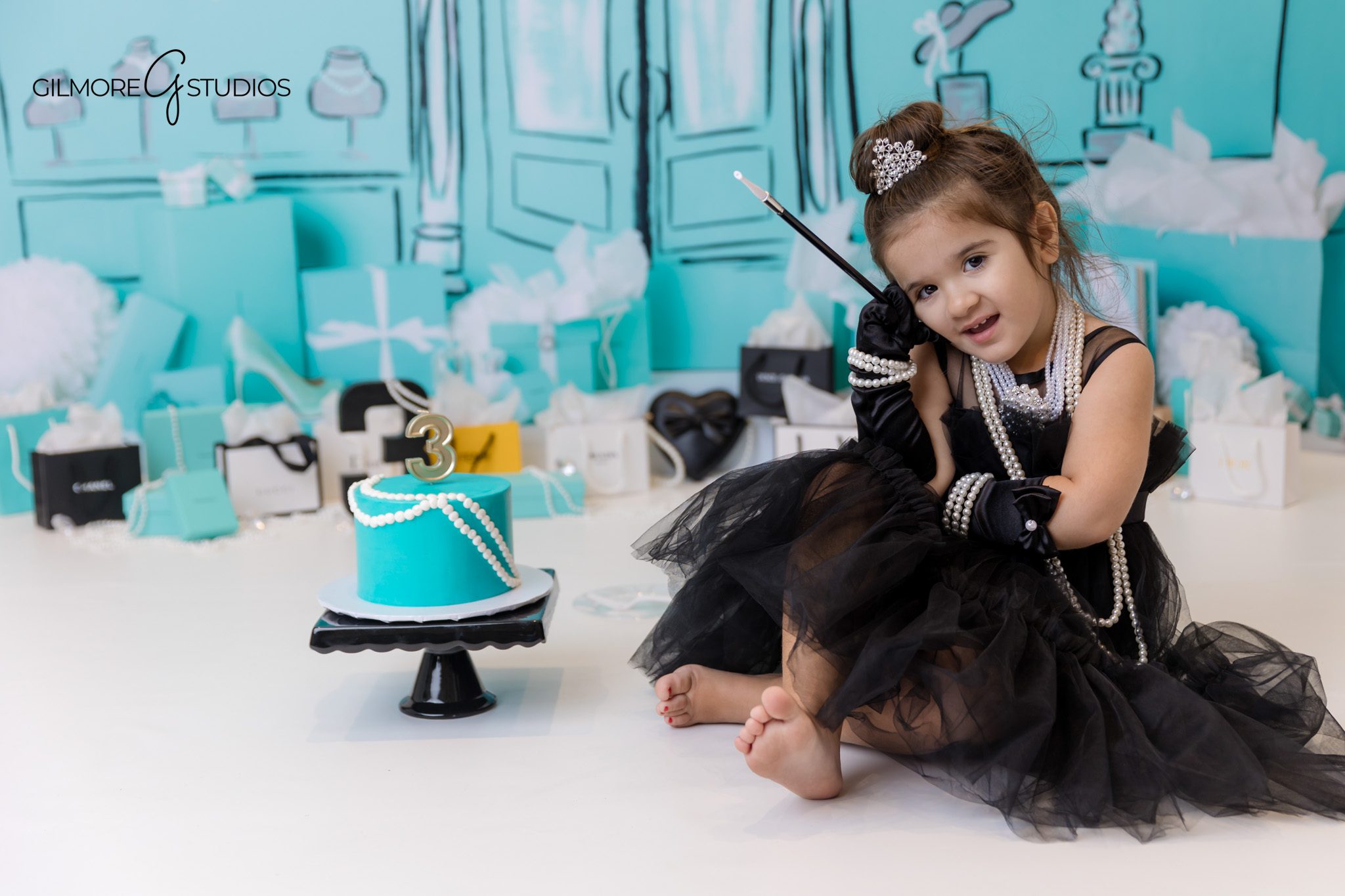 Tiffany box cake photographed during themed 3rd birthday photo session.
Birthday photographer capturing playful moments in Tiffany blue setup.