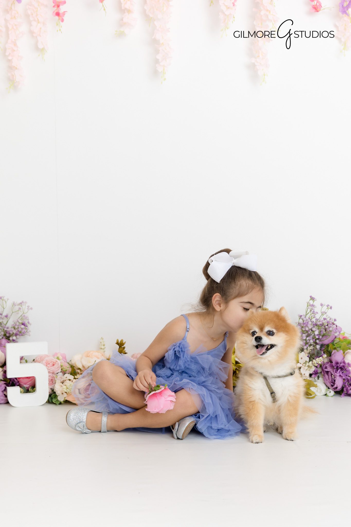 Natural childhood expression of a 5-year-old girl laughing during a birthday photography session with Gilmore Studios