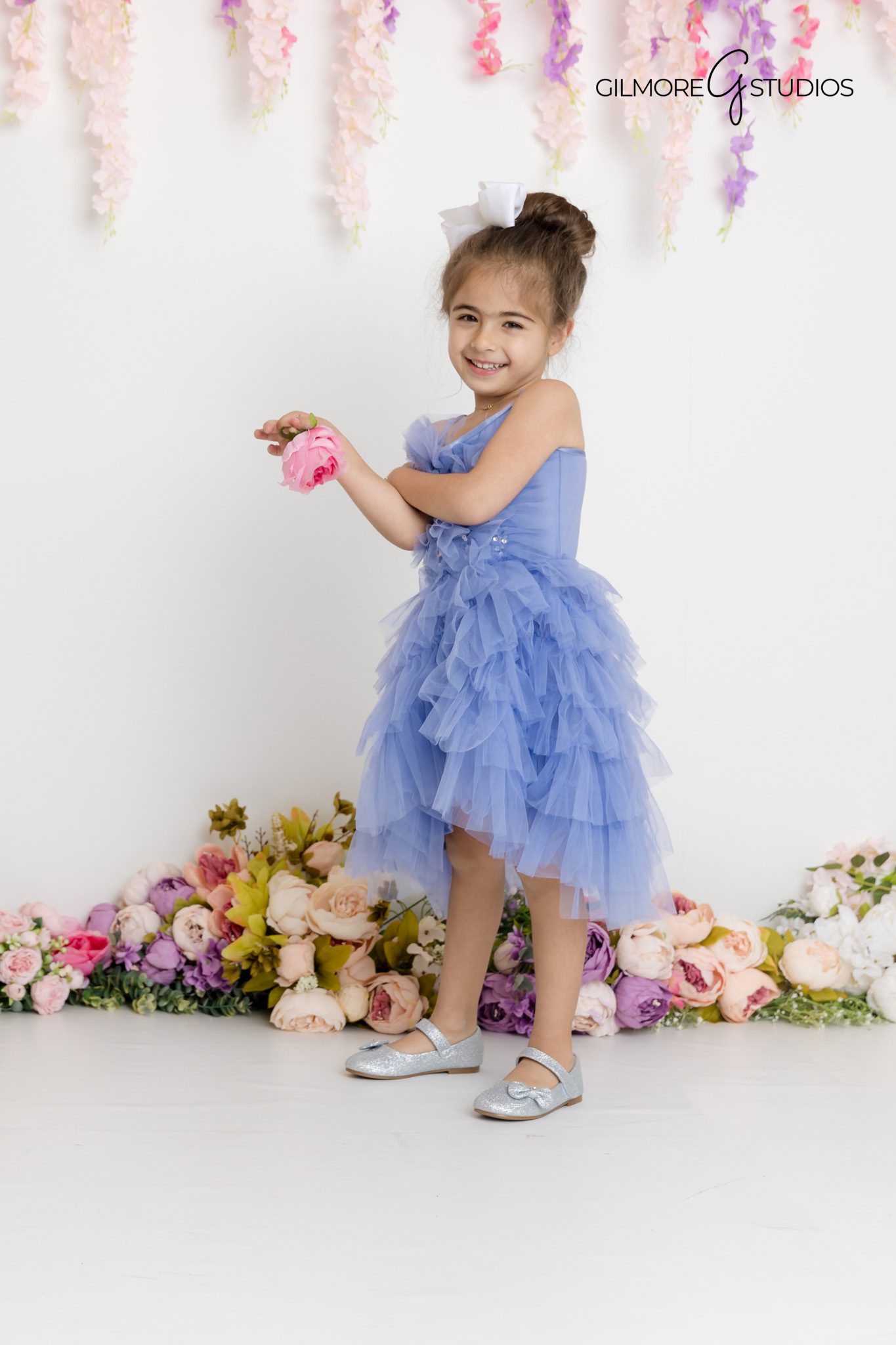 Family of four plus pet dog smiling together during a milestone birthday session in a Gilbert, Arizona photography studio