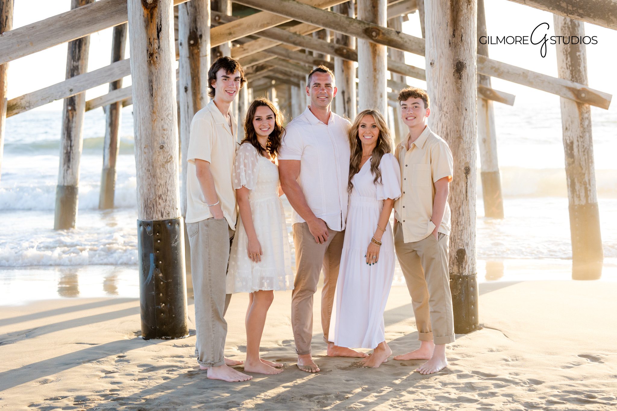 Sunset family photography session with soft ocean breeze in Newport Beach.
Newport Beach family photographer capturing joyful pier portraits.
