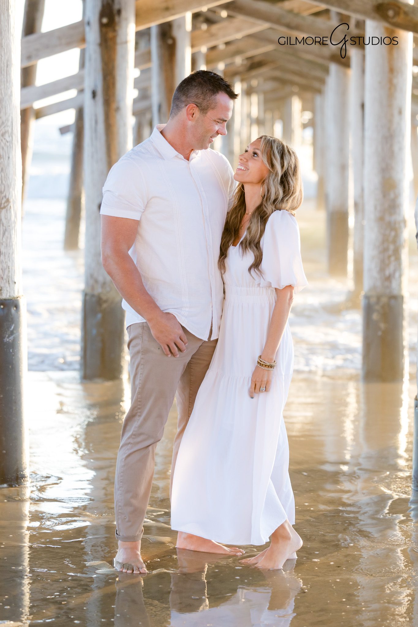 Natural light photographer capturing warm sunset portraits at the pier.
Newport Beach Pier family portrait photography with glowing sky backdrop.