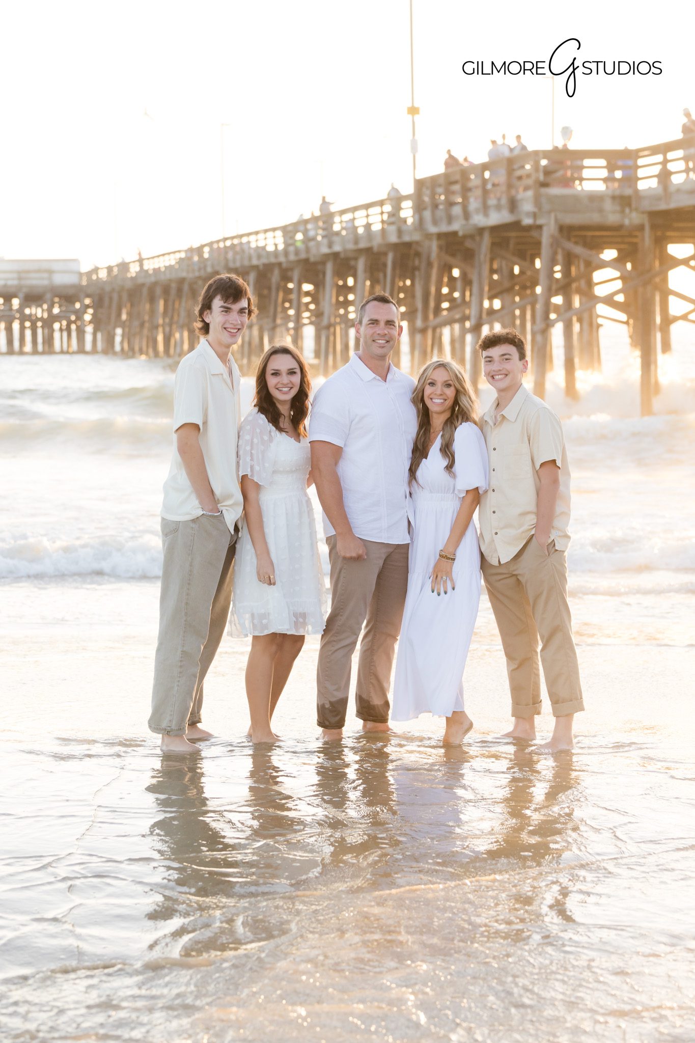 Family portrait session with soft sunset colors near Newport Beach Pier.
Kids playing during sunset family photography at Newport Beach Pier.
