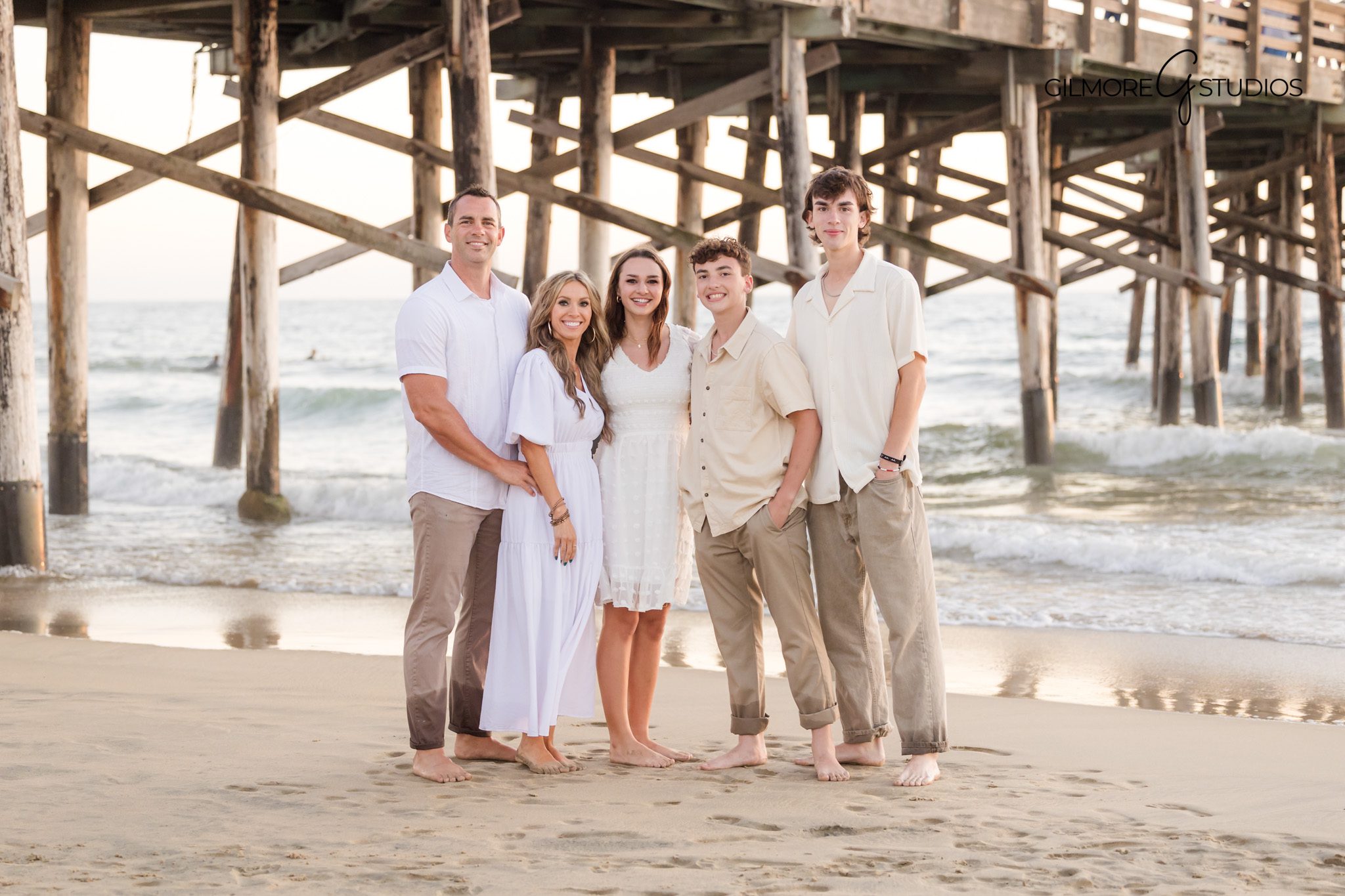 Newport Beach photographer documenting candid family interactions at sunset.
Family portraits with soft golden light at Newport Beach Pier.