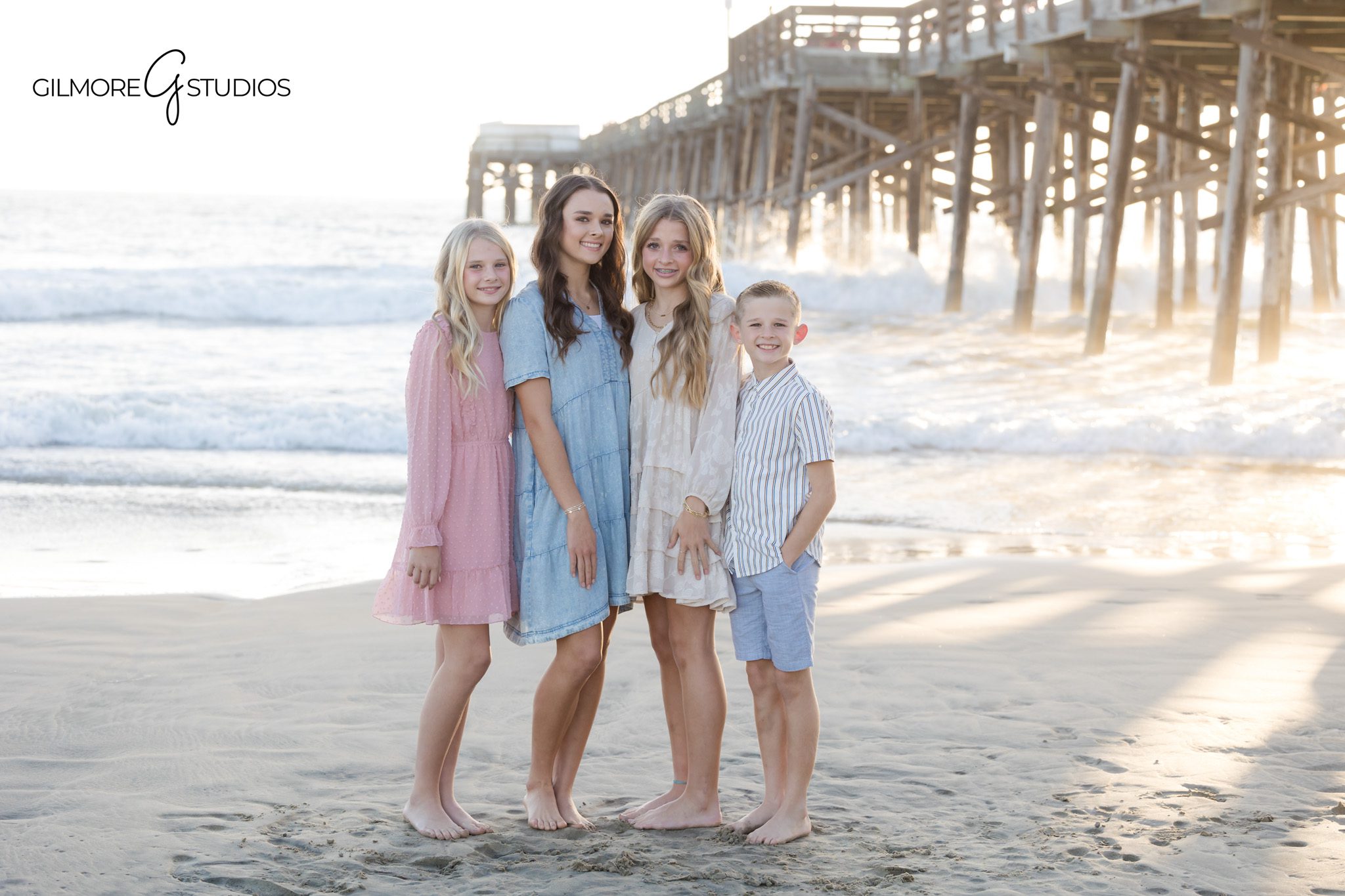 Candid family photography at Newport Beach Pier mini sessions on the sand

Newport Beach family portrait photographer photographing parents walking with kids near the pier