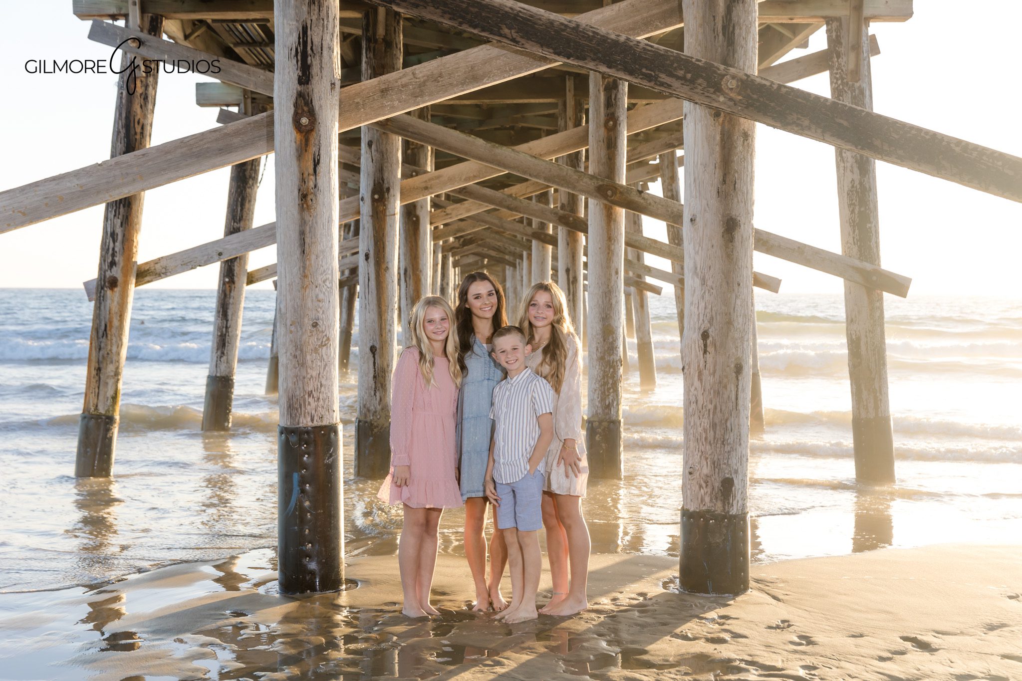 Newport Beach family photography minis of siblings hugging near the water

Pier family portrait photographer capturing playful pose during Newport Beach minis