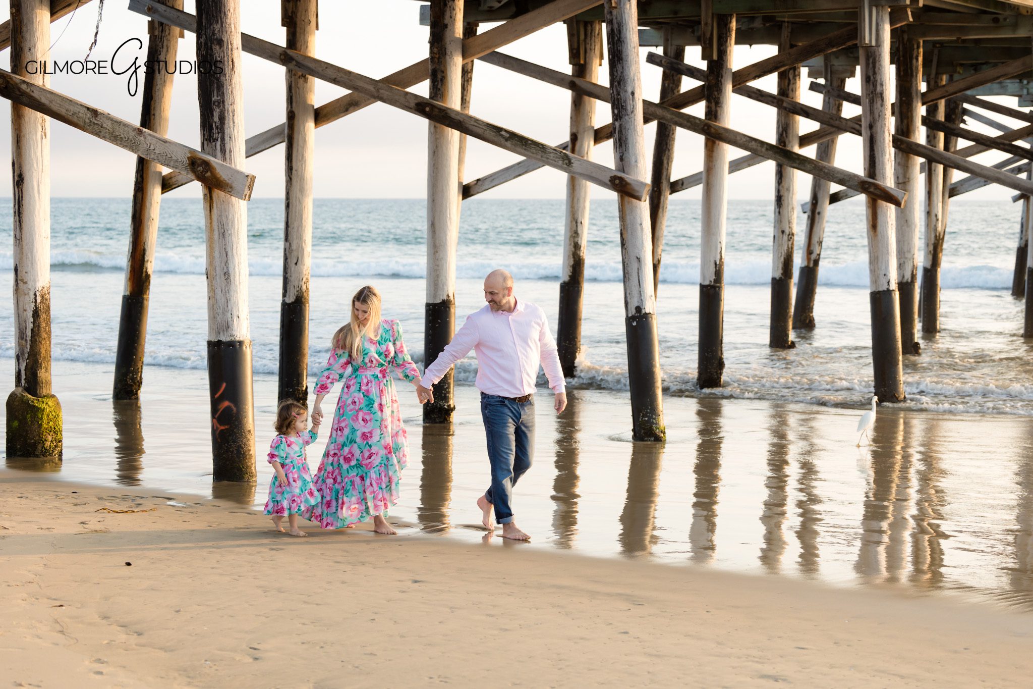 Newport Beach family photographer capturing joyful milestone images.

Portrait photography of toddler turning two at Newport Pier.